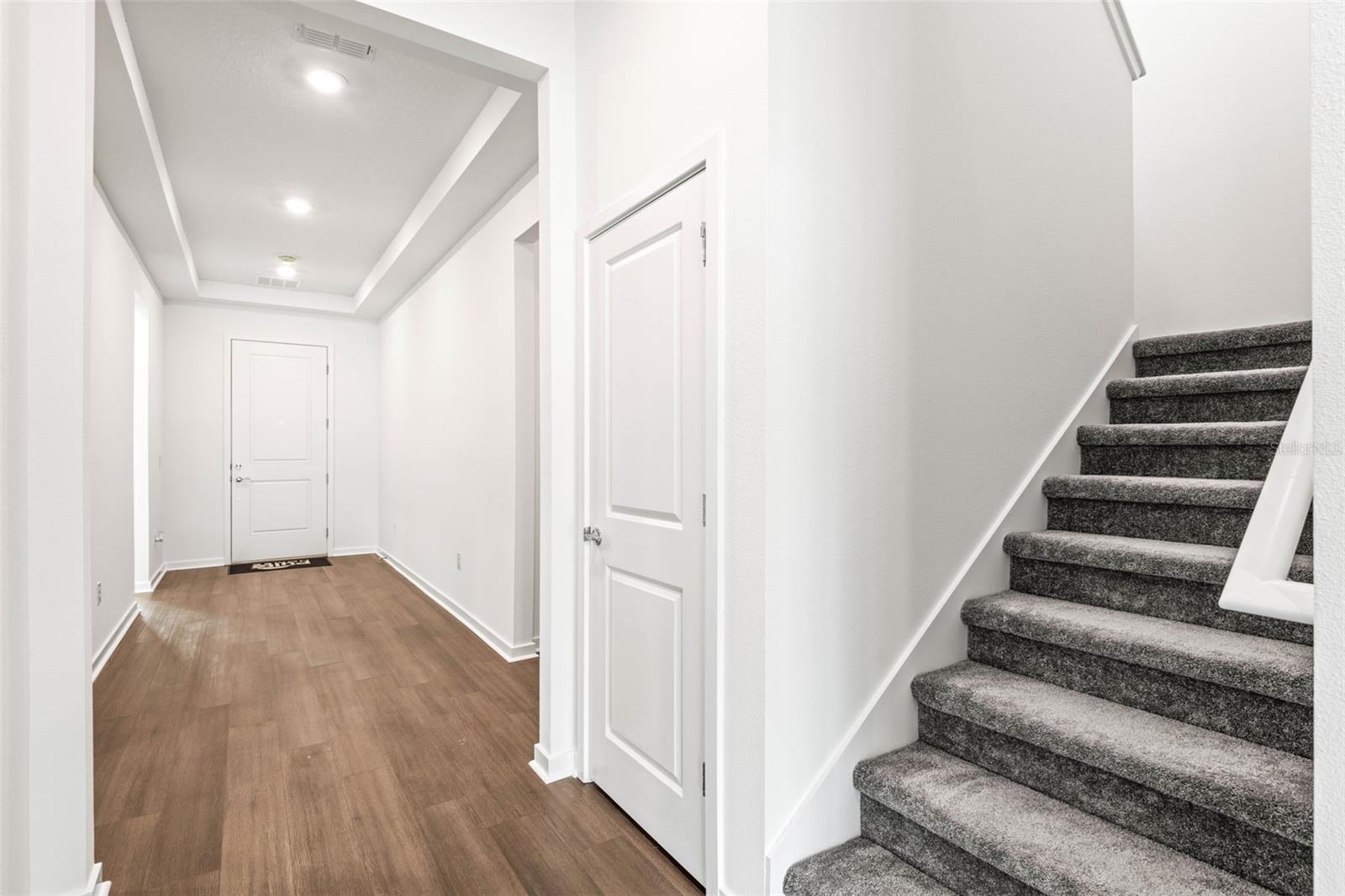 Foyer looking back towards front door. Closet beside stairs goes underneath stairs and around for plenty of extra storage.