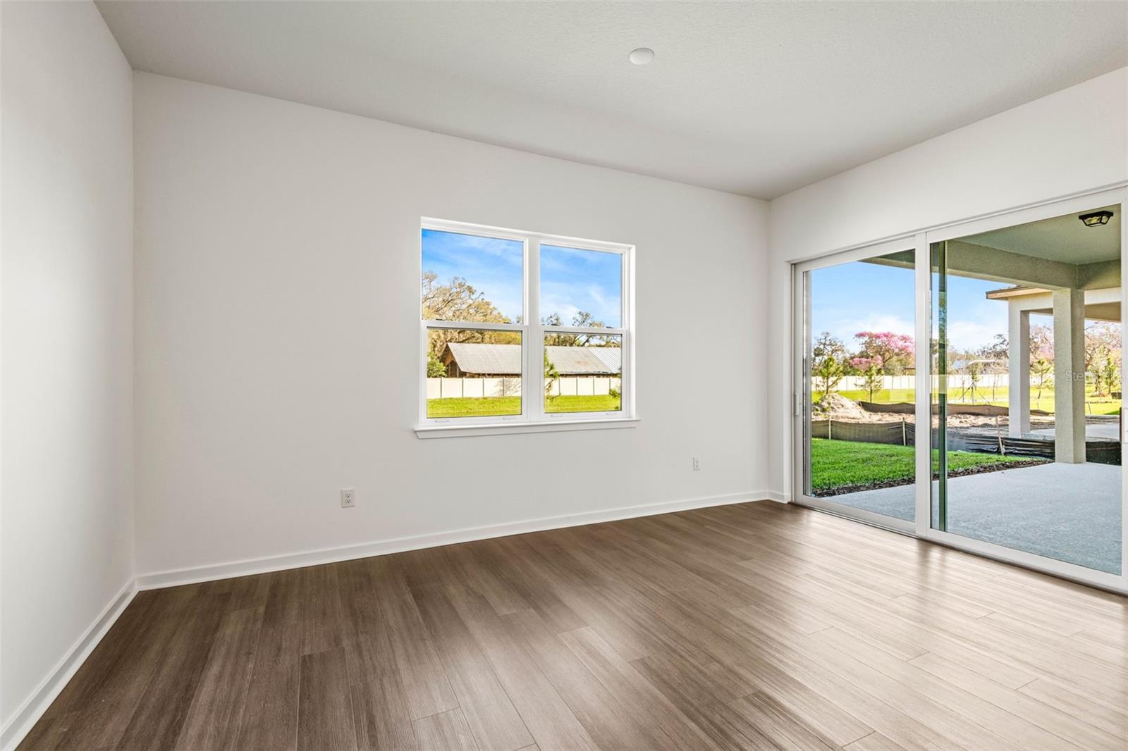 Dining area with plenty of natural light and sliding glass doors on to the covered lanai.