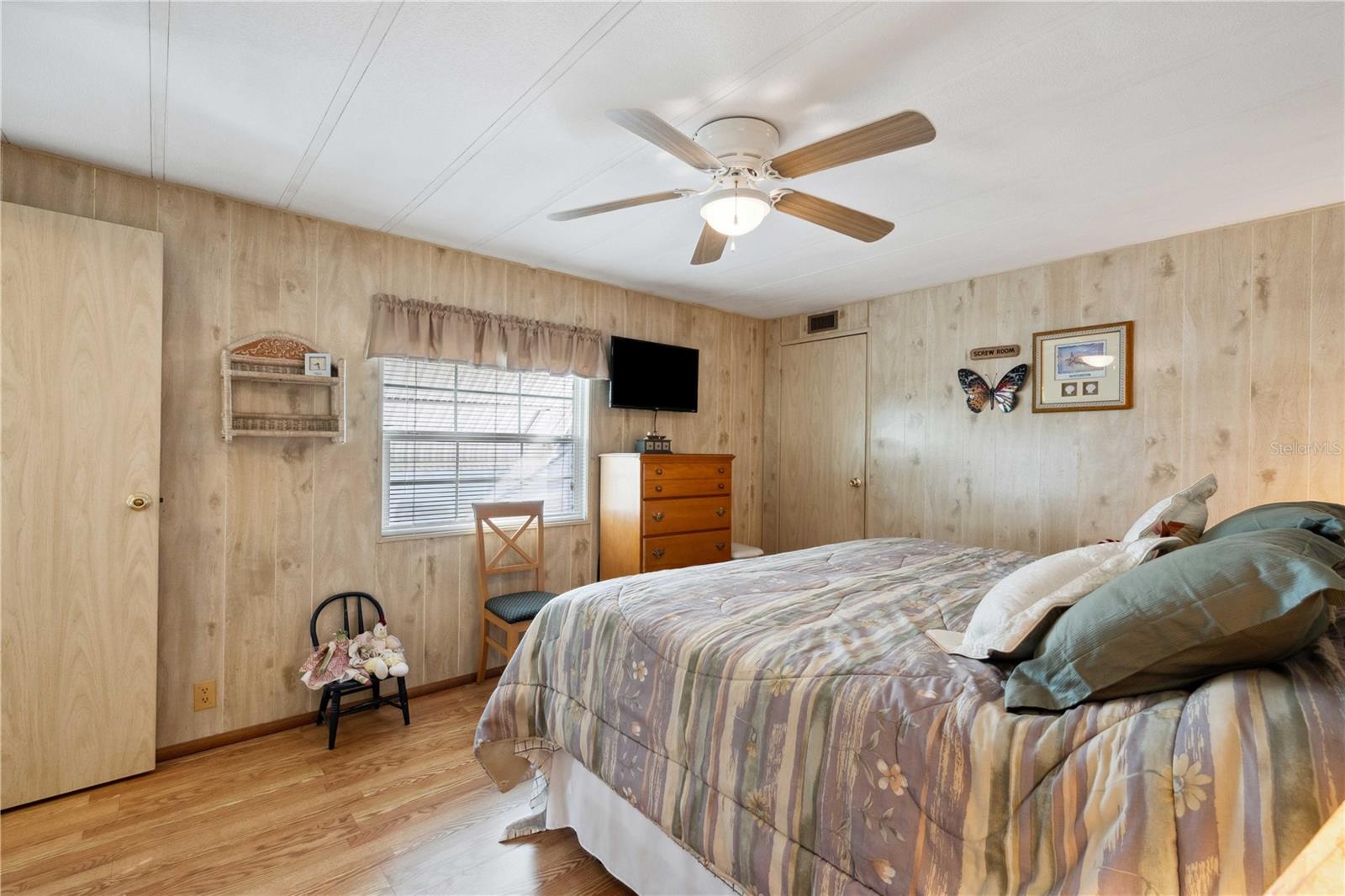 Primary bedroom has laminate flooring, ceiling fan, and walk-in closet.