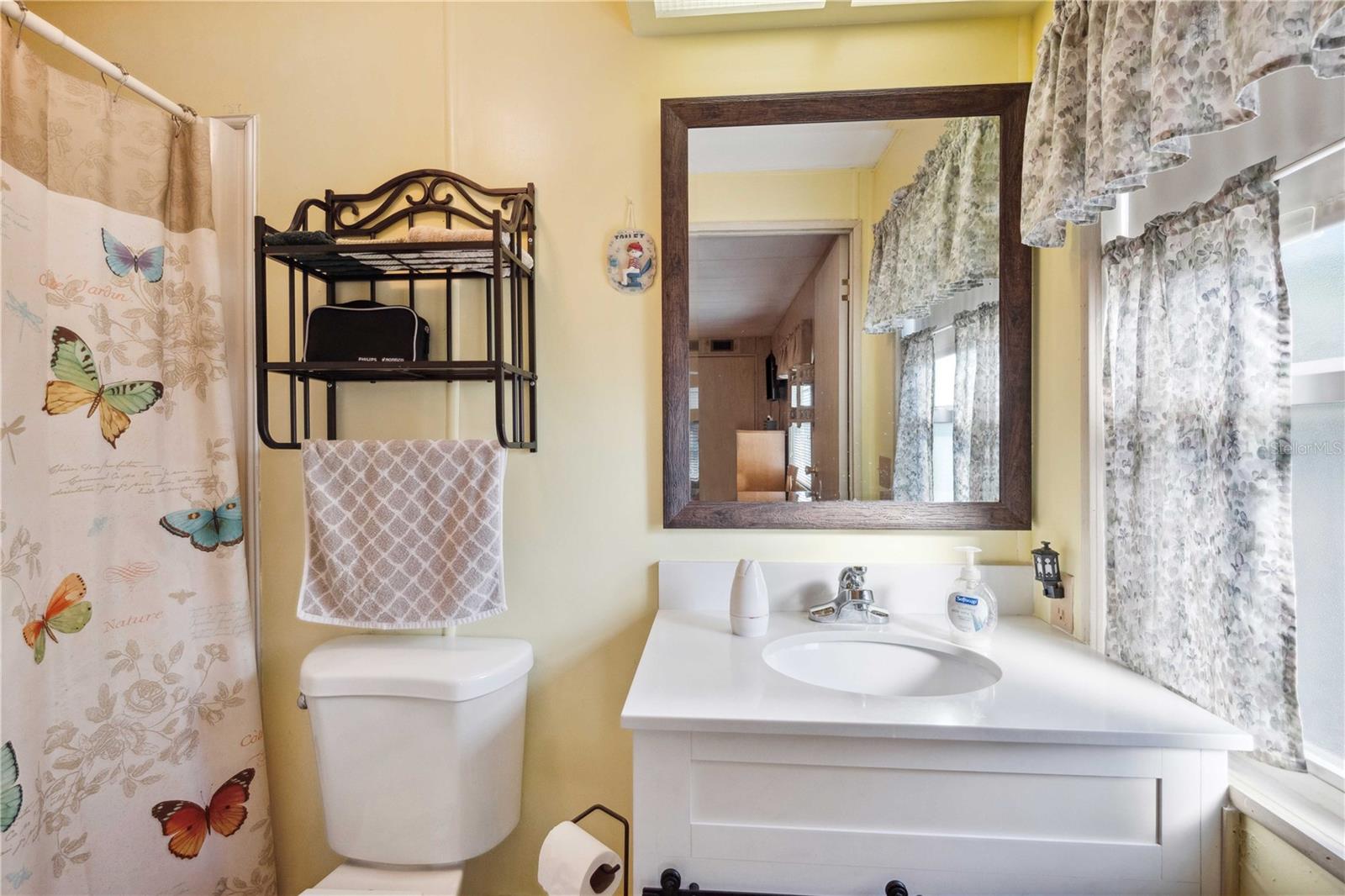 Primary bath has step-in shower and updated vanity.