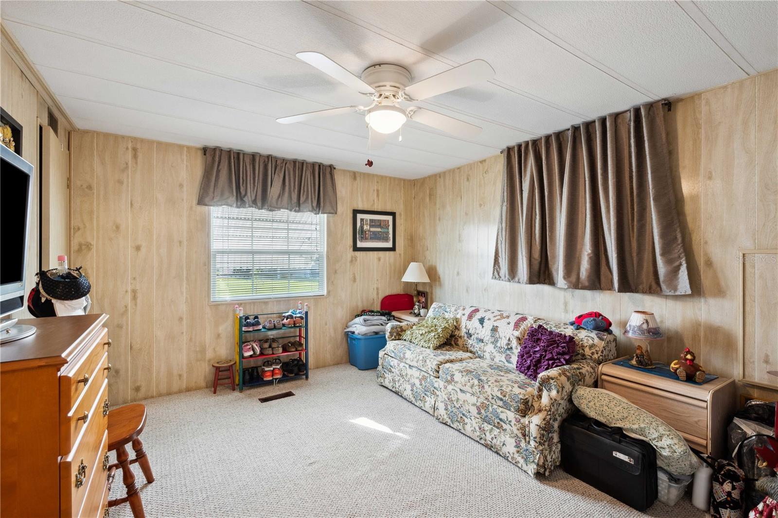 Bedroom two has ceiling fan, walk-in closet and carpeting.