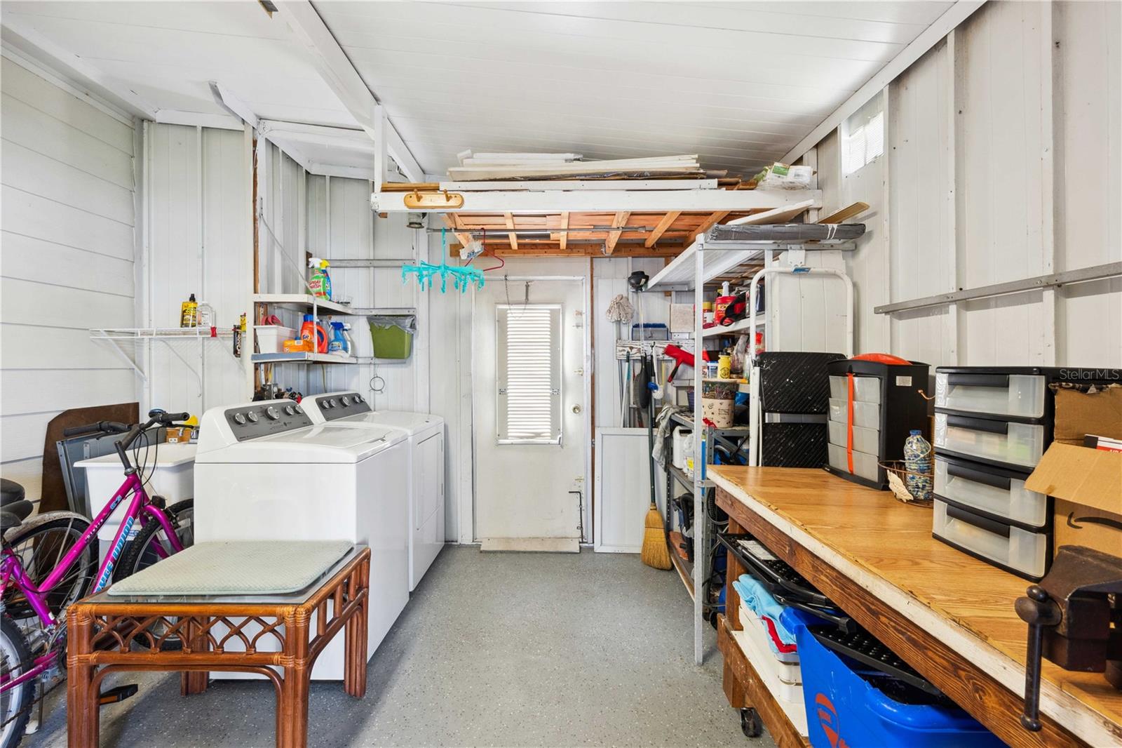 Utility room has washer and dryer just off the screen room.