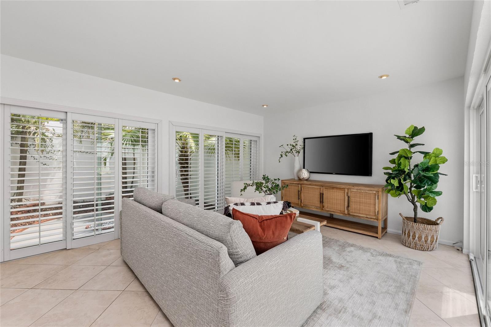 Living Room - beautiful planation shutters and great view of private patio.