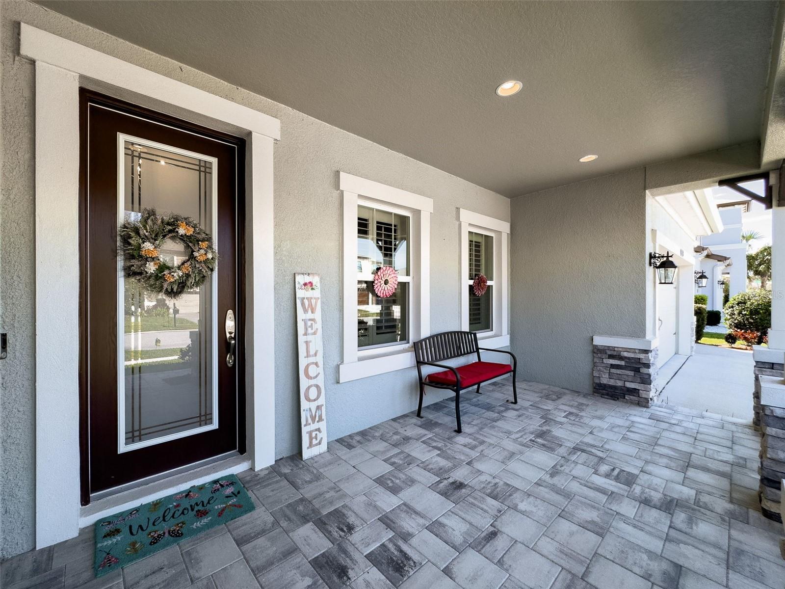 Beautiful Covered pavered porch leads to the Front Door