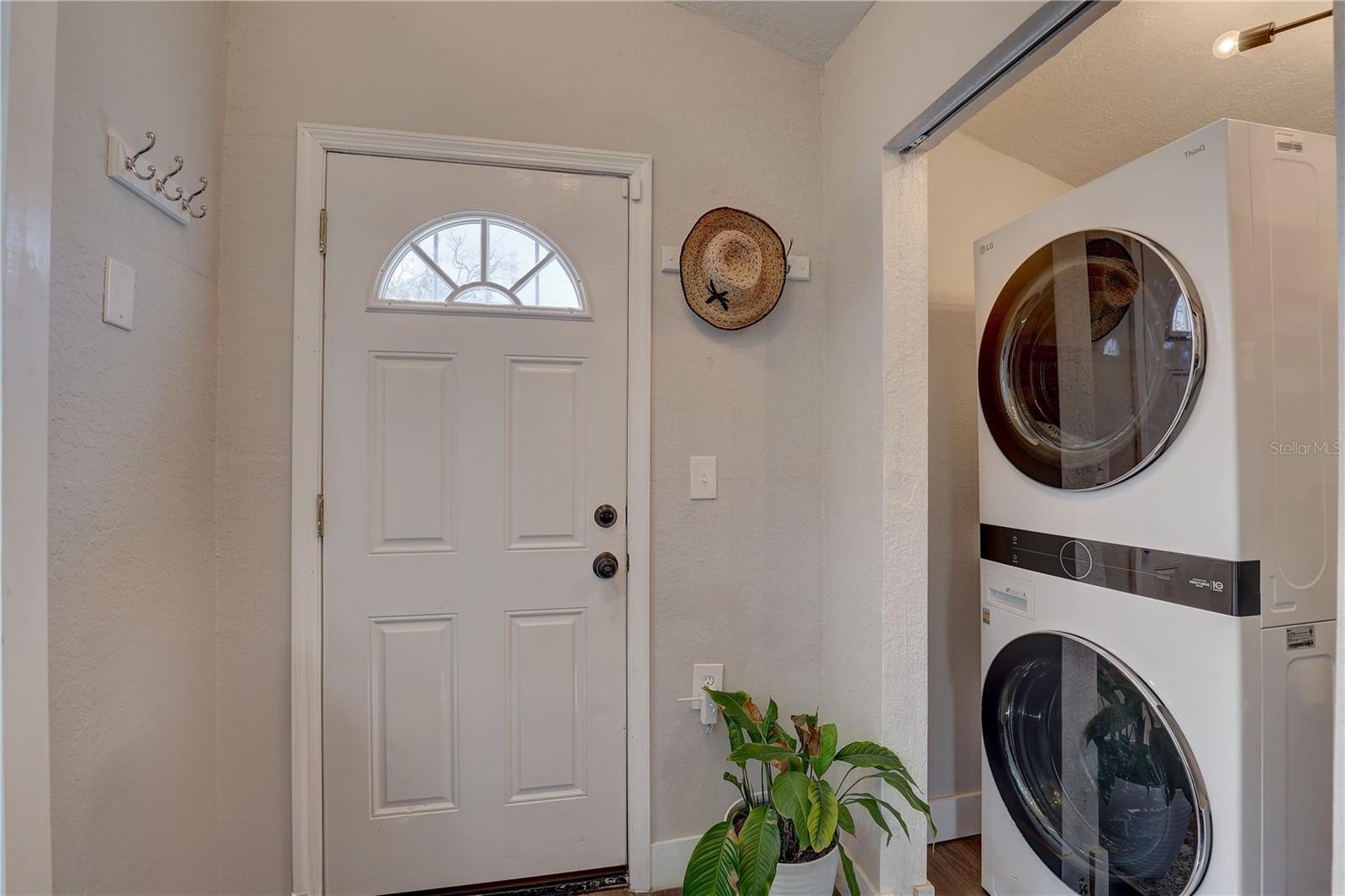 Laundry/storage closet with side door to the back yard/alley