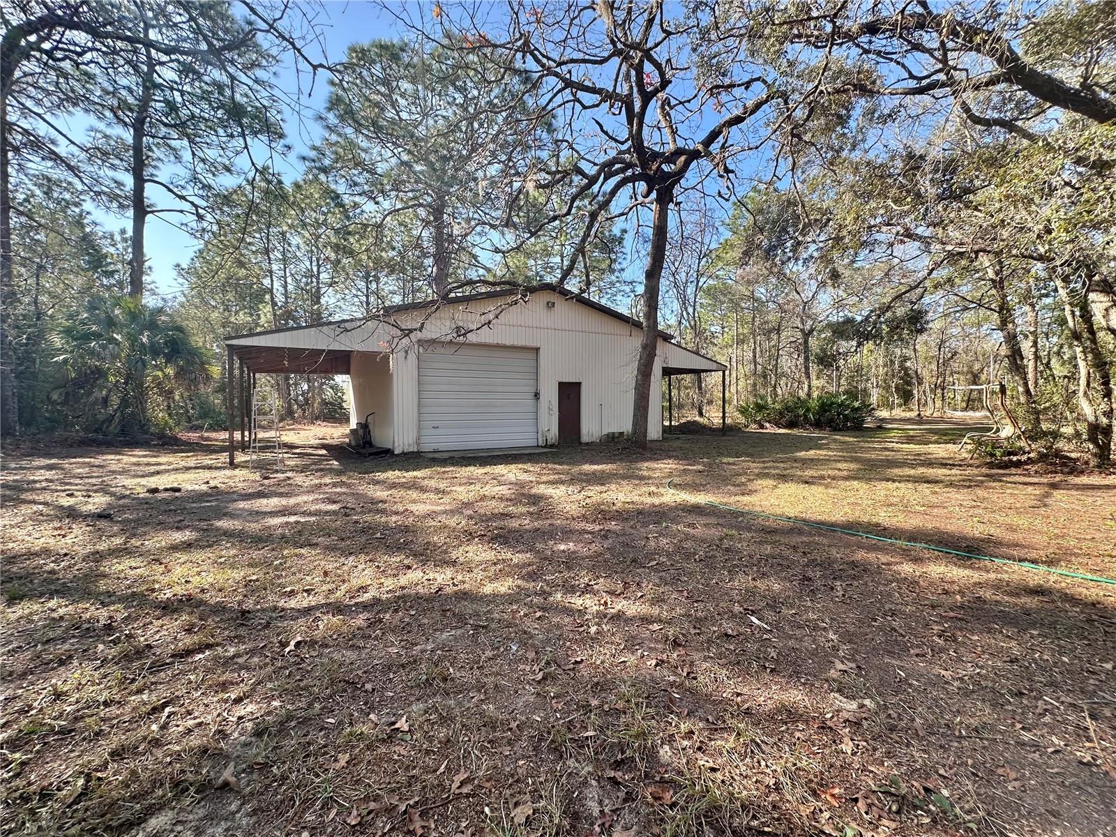 View of the outside stand alone detached workshop behind the house.