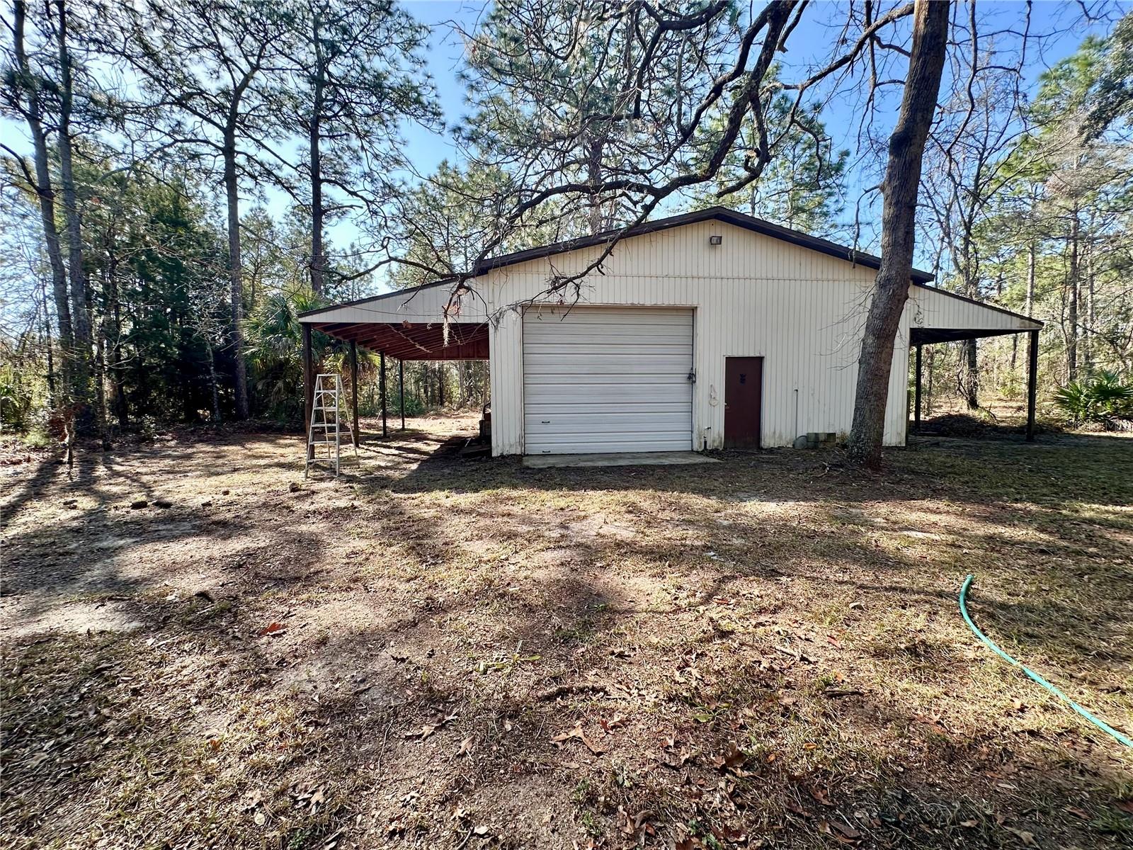 View of the outside stand alone detached workshop behind the house.