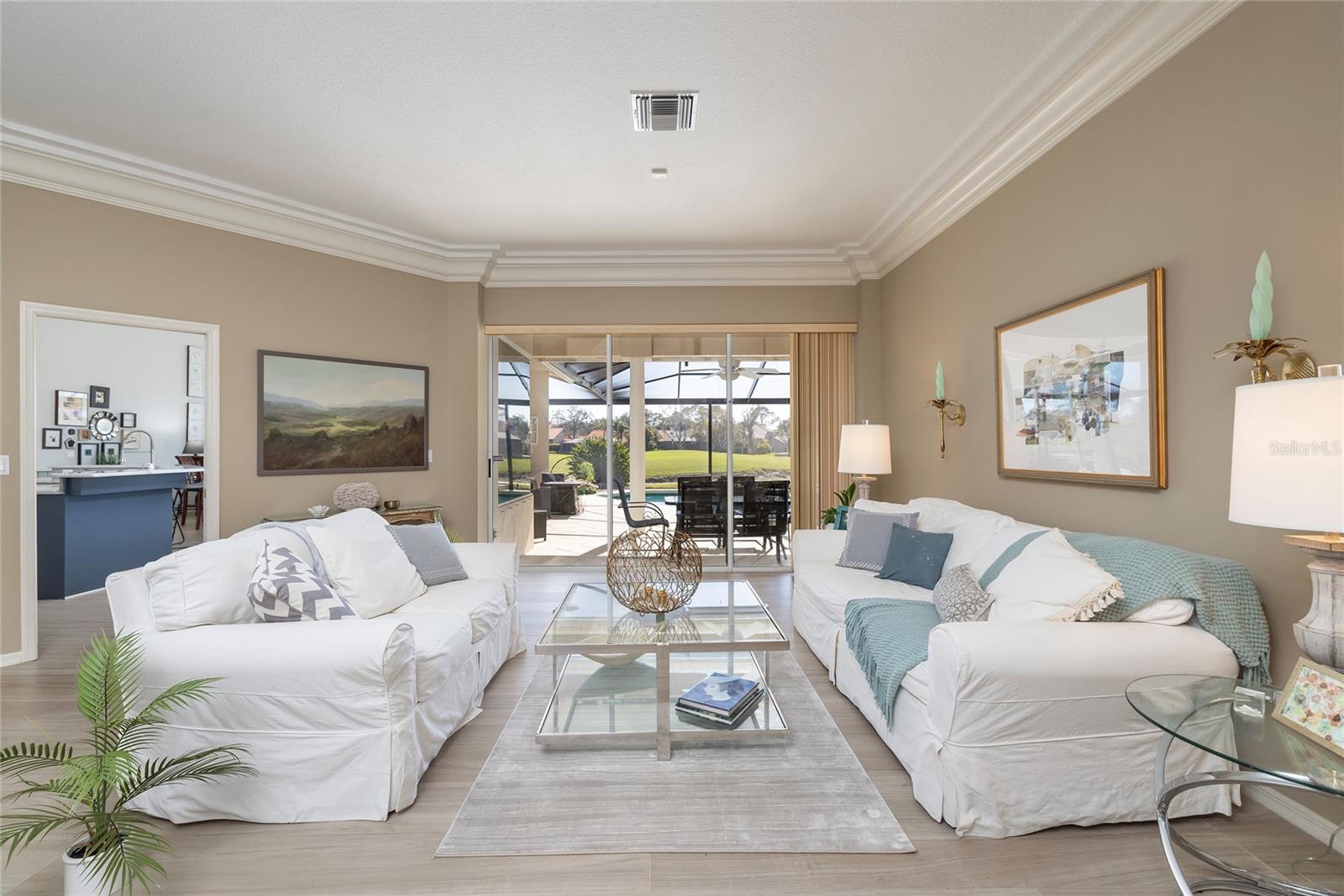 Formal room view of pool and golf course