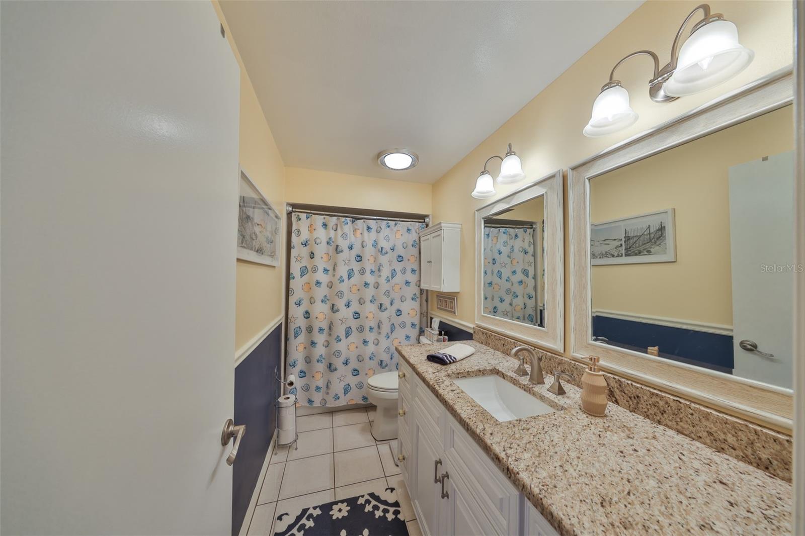 Guest bathroom is fully updated with granite and new cabinets