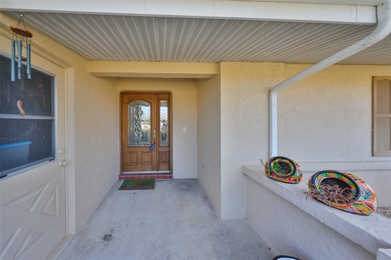 A large covered front entrance and lead glass door highlight the entrance.