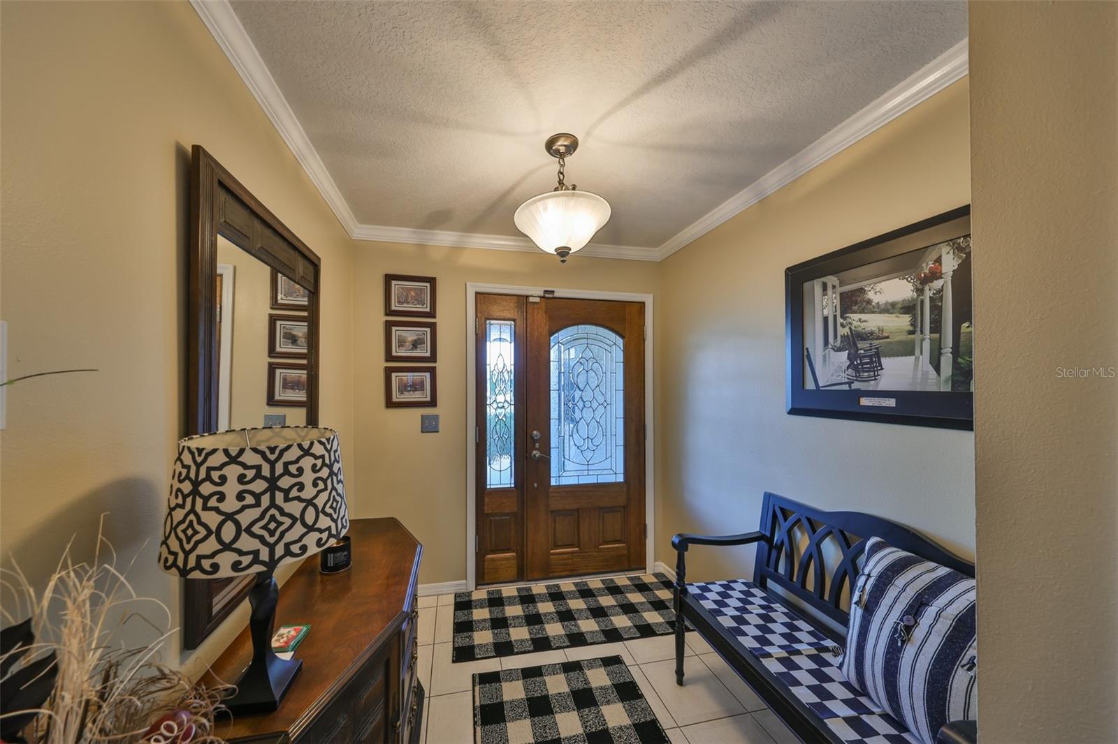 A well defined foyer with lots of natural sunshine welcomes guest and family members alike.  Notice the crown molding and neutral paint tones.