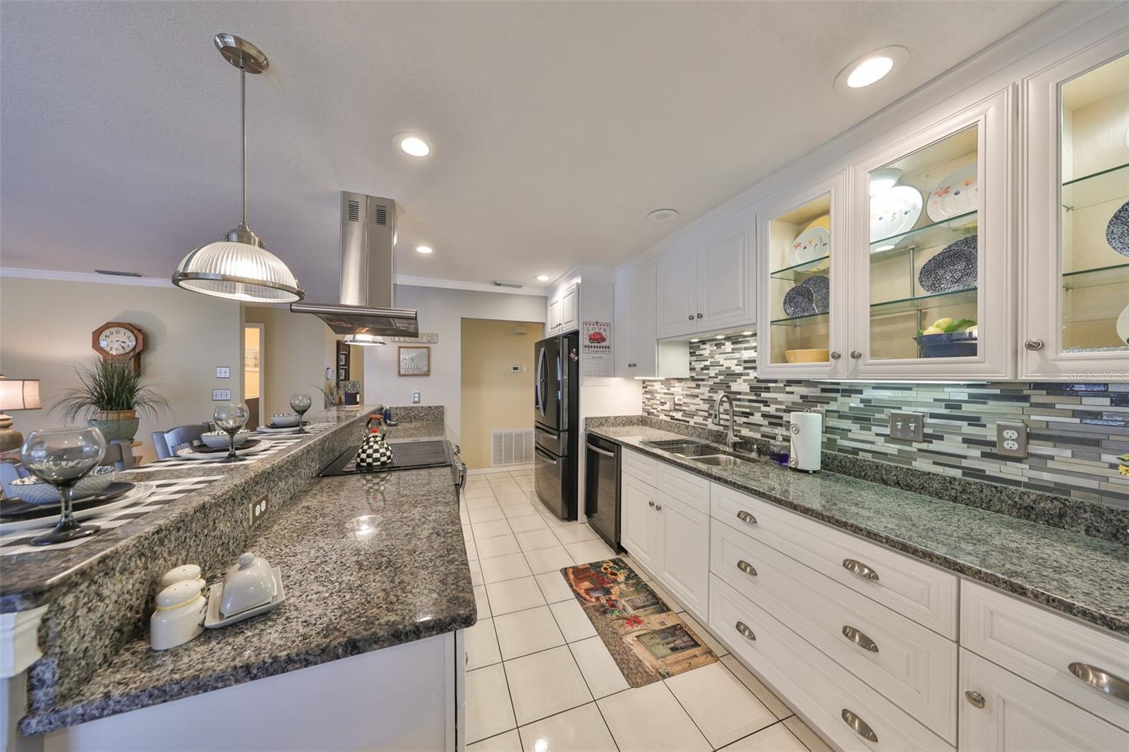 Beautifully updated kitchen is modern and contemporary with granite counters, wood cabinets and lots of bright lights.