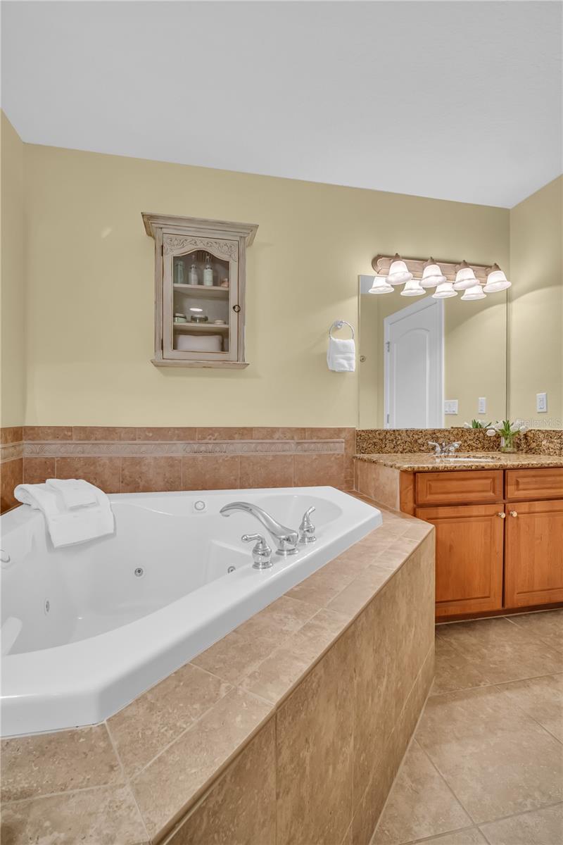 Jetted tub with double vanity.