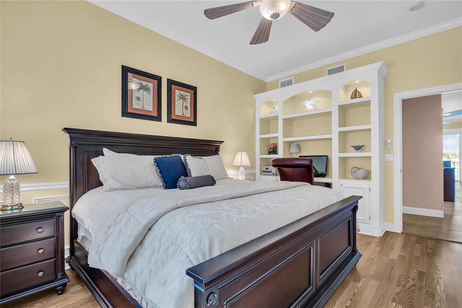 A stylish second bedroom on the second level featuring a built-in office nook.