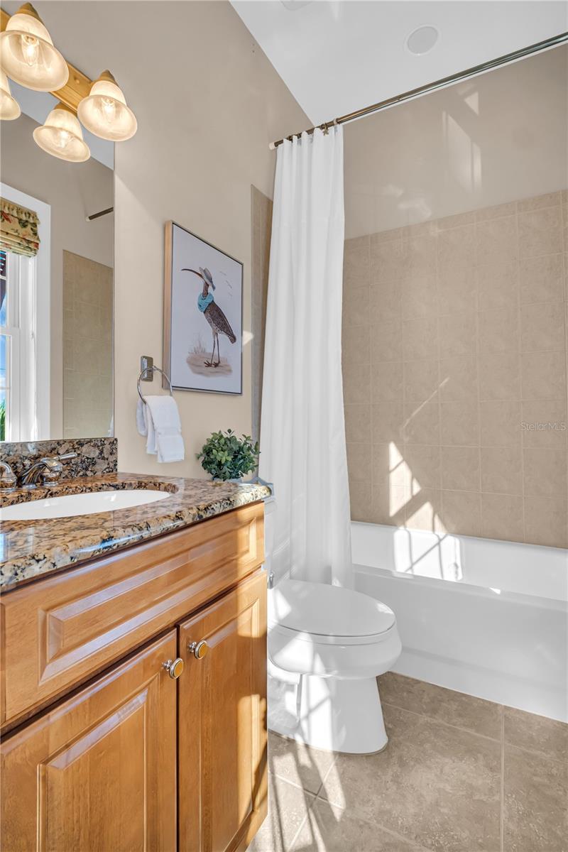 The attached third bathroom hosts a single vanity and tub/shower combo as well.