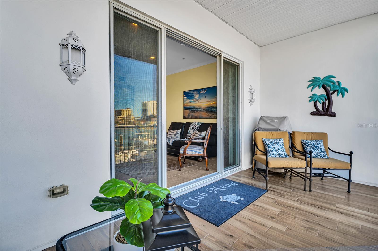 Second level balcony leading into a bright, open living room, with panoramic ocean views, and stylish furnishings.