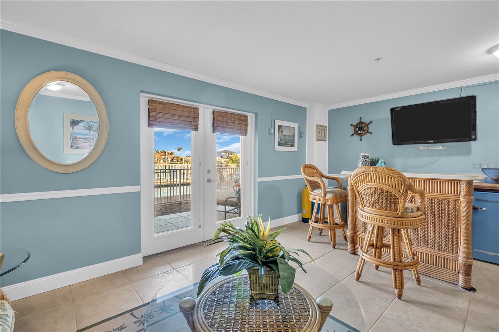 Bright and airy Florida room on the ground level with large glass doors that offer amazing water views.