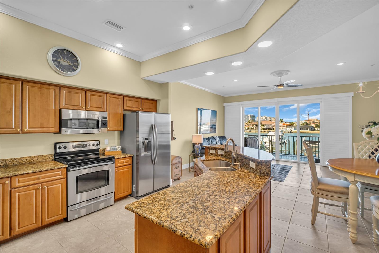 Kitchen boasts 2-tier counter space with granite countertops and stainless steel appliances.