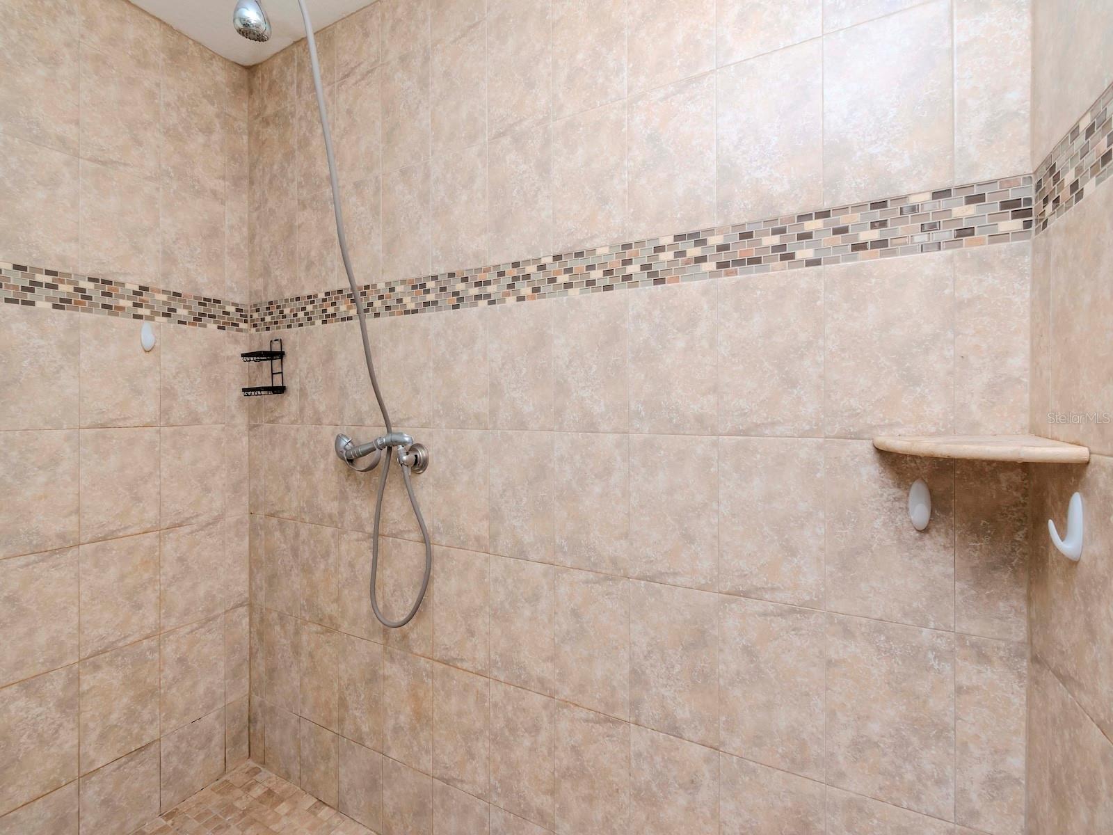 LARGE WALK IN SHOWER WITH BEAUTIFUL TILE WORK