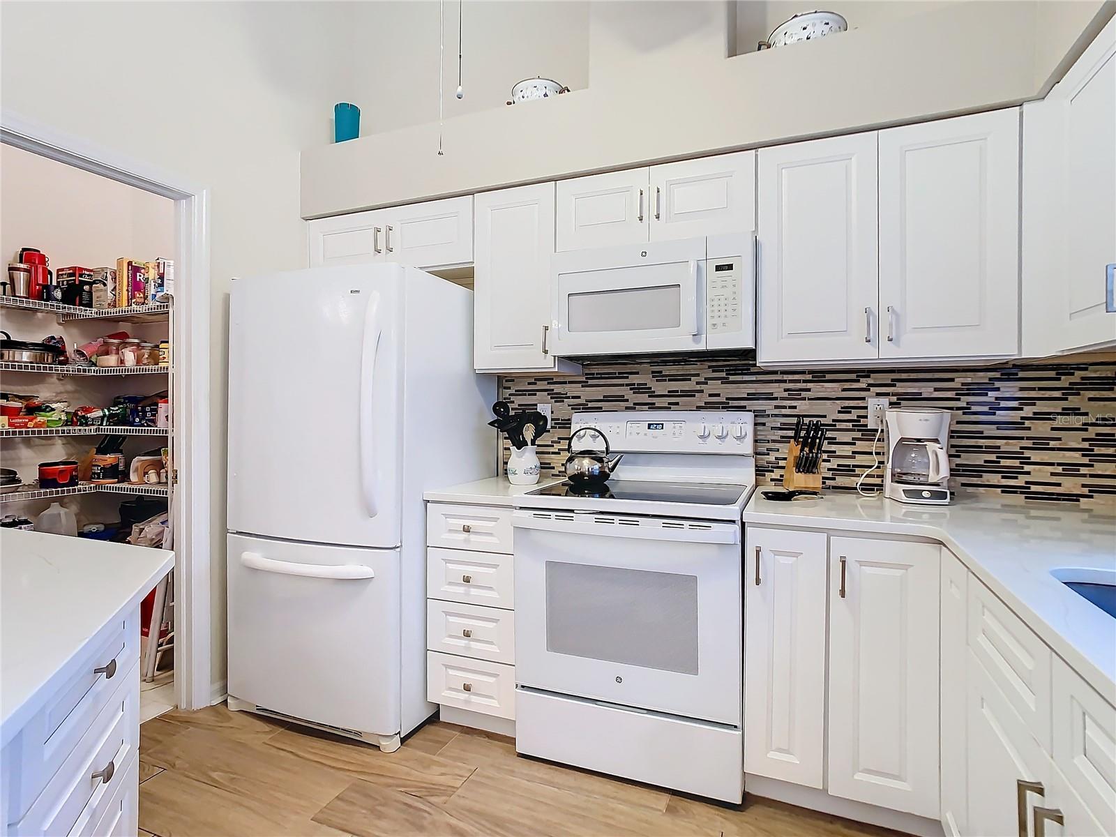 Plenty of cabinets and drawers for your kitchen hardware. The GE range was purchased in 2024. Note all open space above the counters for your curios and other show pieces.