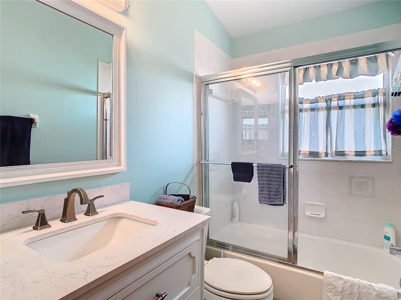 Guest bathroom was remodeled in 2021 to include solid surface counter, high boy vanity and upgraded ceramic tile. This is a tu /shower combination.