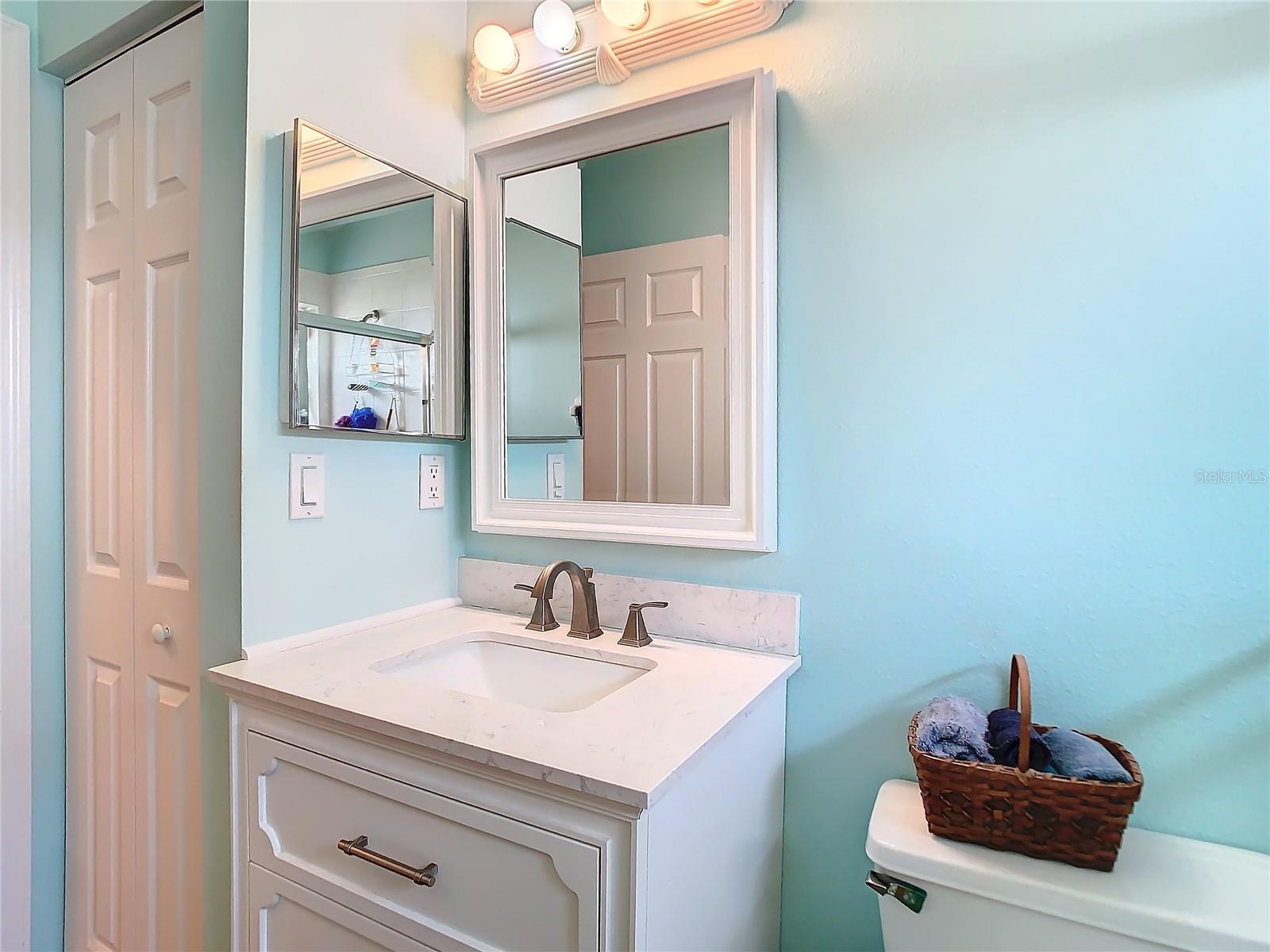 Guest bathroom also has a linen closet.