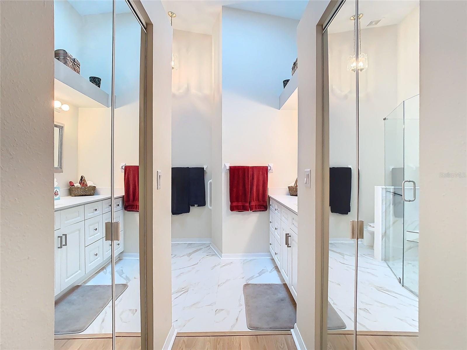 The primary bathroom has 2 large walk in closets accessed through the full mirror bifold door. Plenty of room for your wardrobe. The flooring is an upgraded tile product Gives the room a very rich look to it.