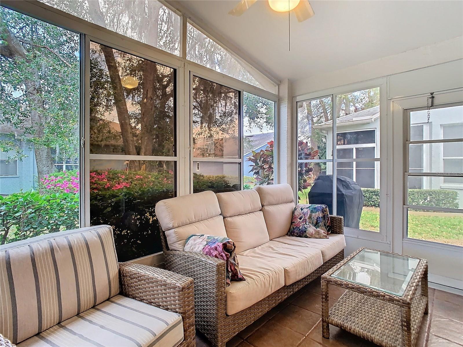 The rear patio sits off the kitchen on ceramic tile. The area is screened and has sliding windows. There is a cement platform off the patio for your oudoor cooking necessities.