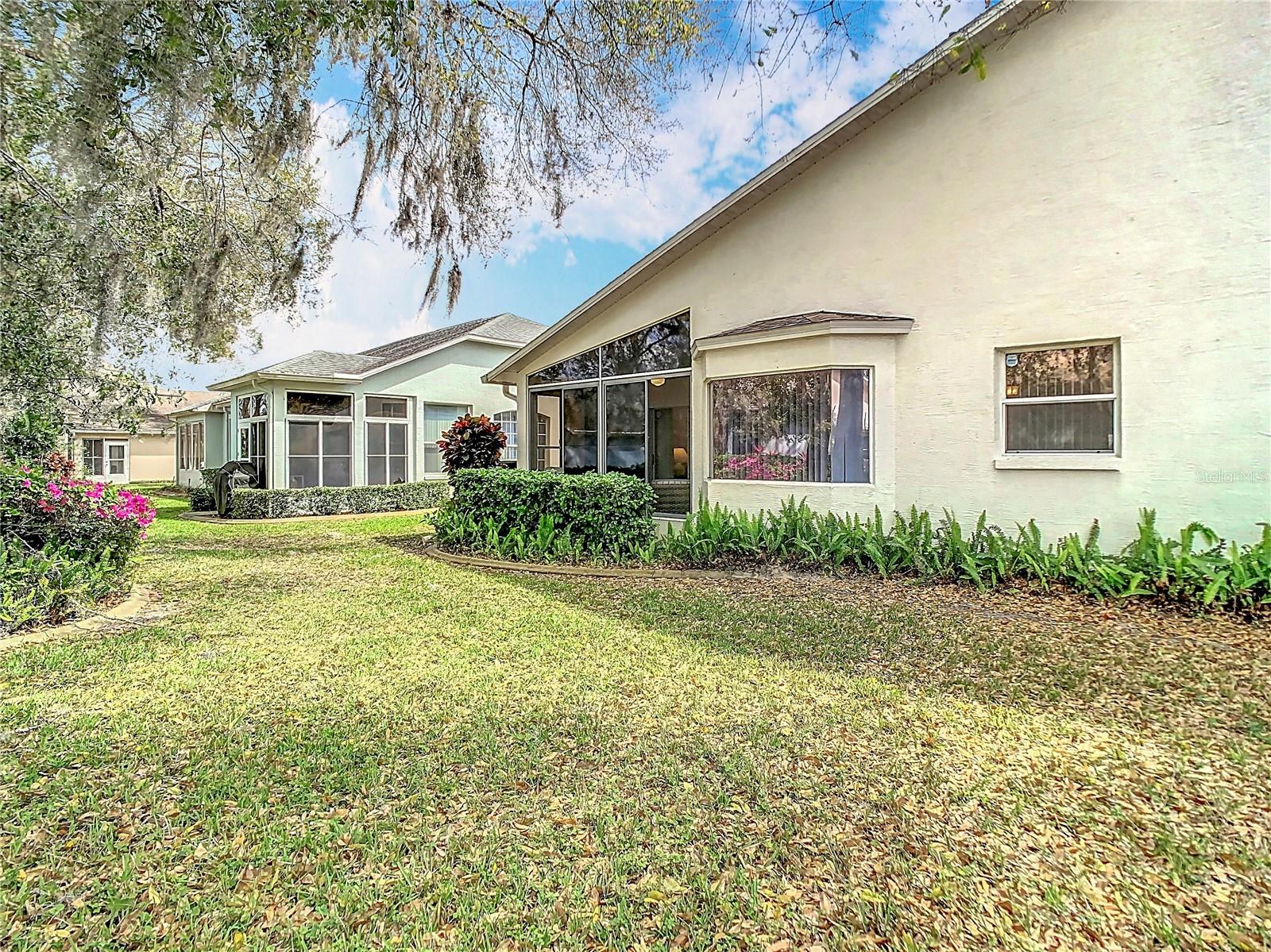 Back yard area is well maintained with your HOA fees. From left to right is the rear patio, sit in bay window, and kitchen window over the sink.