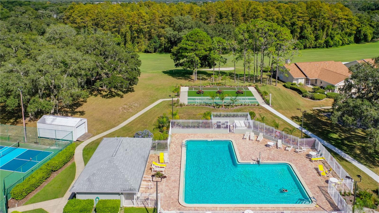 Outside you have a heated inground pool with a cabana bathroom. At the rear of picture are shuffle board and bocce ball for your entertainment.