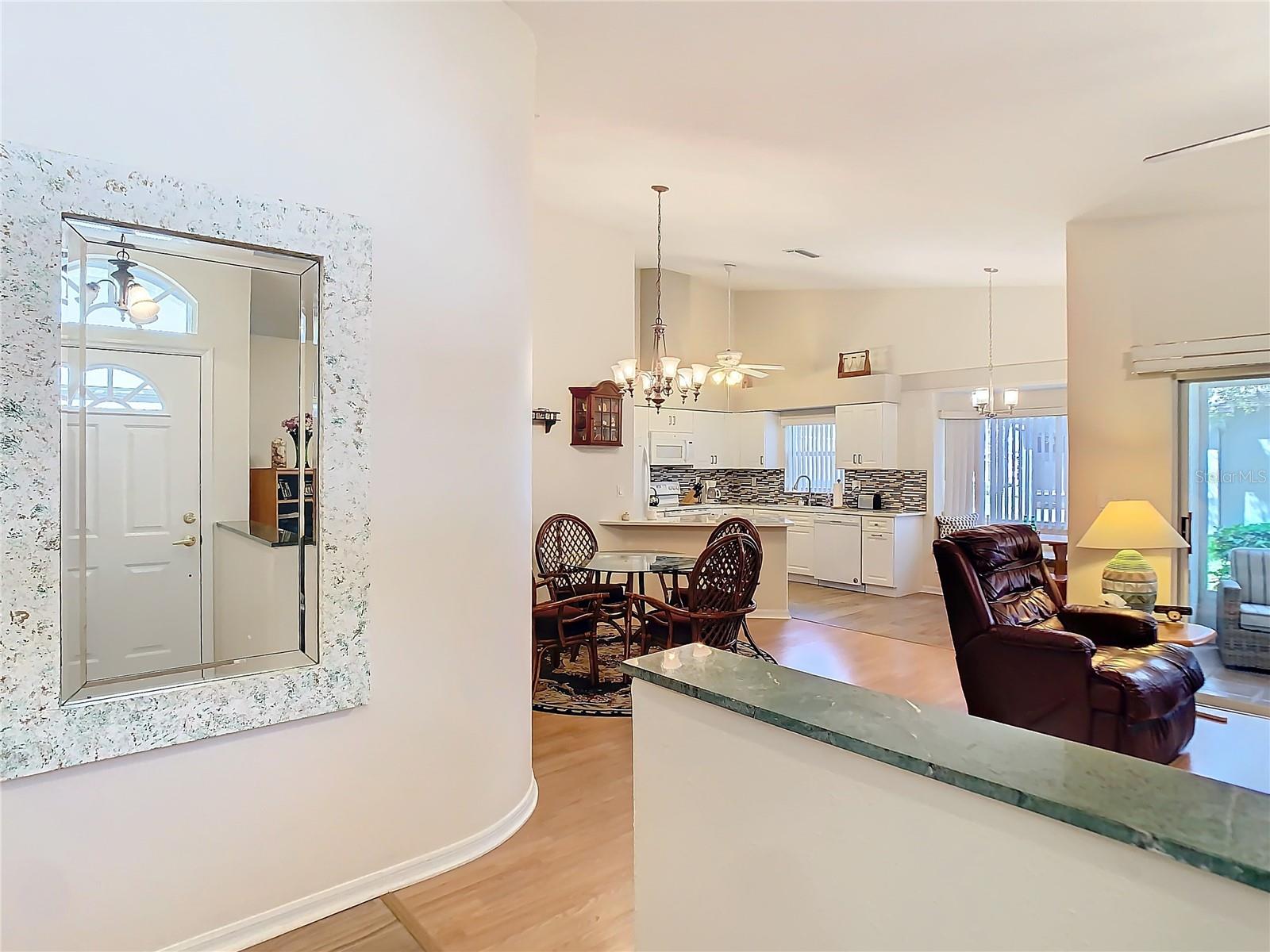 This is view from entry way. The open floor plan gives you plenty of space. Property is being sold with a furnished option. Great opportunity for seasonal buyers if desired.