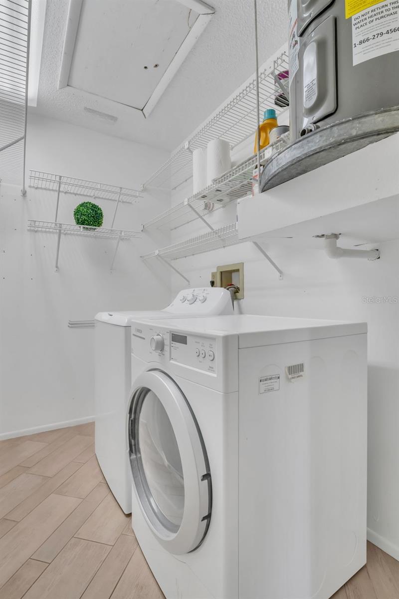 Large laundry room with newer tile floor & extra storage space~