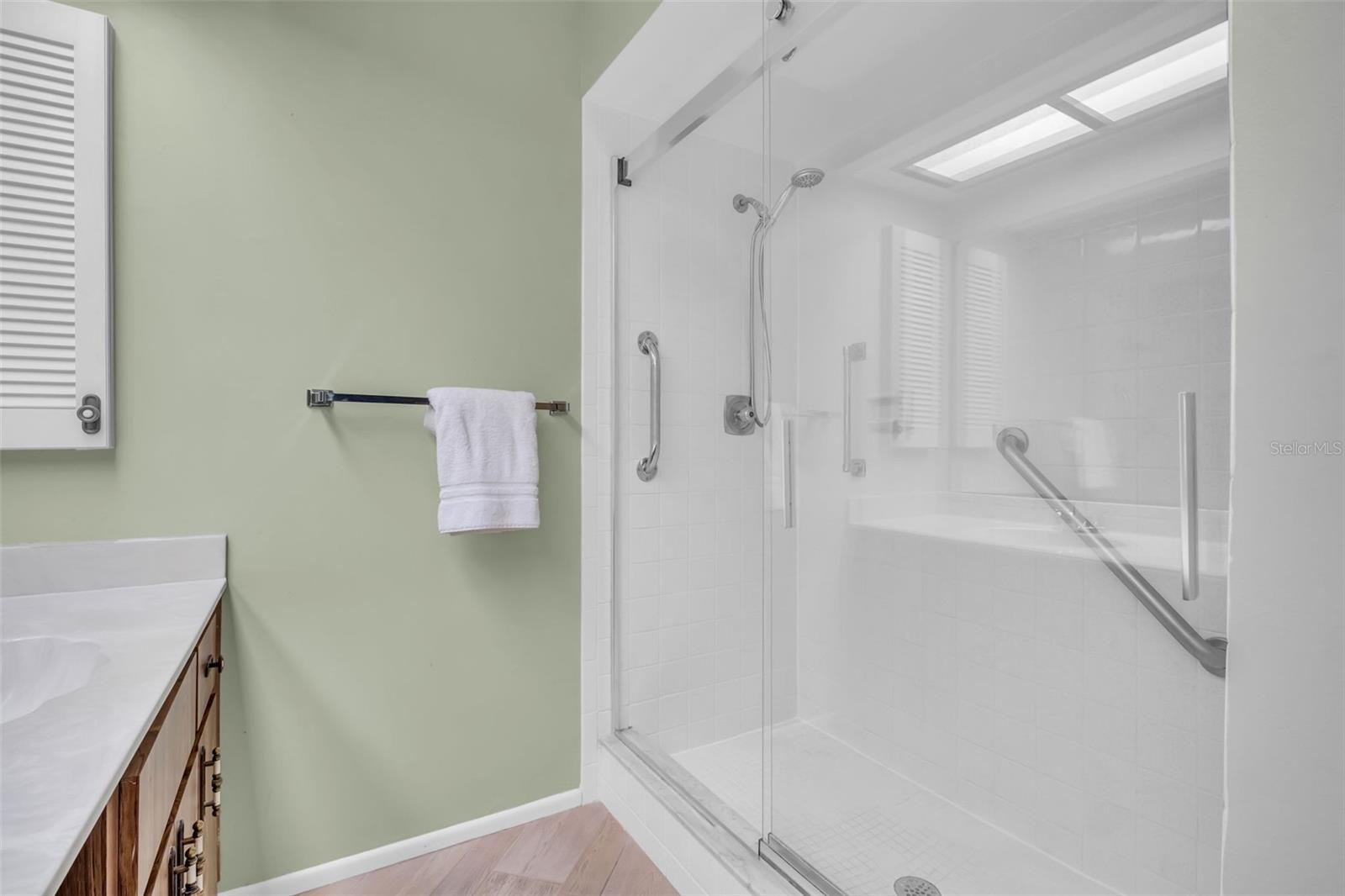 Updated step in shower with sturdy glass doors & safety bars~