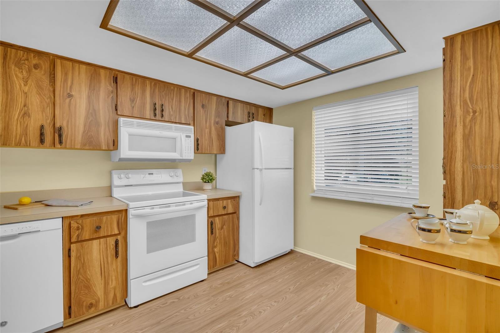 Newer flooring & window, matching appliances, & generous cabinets~