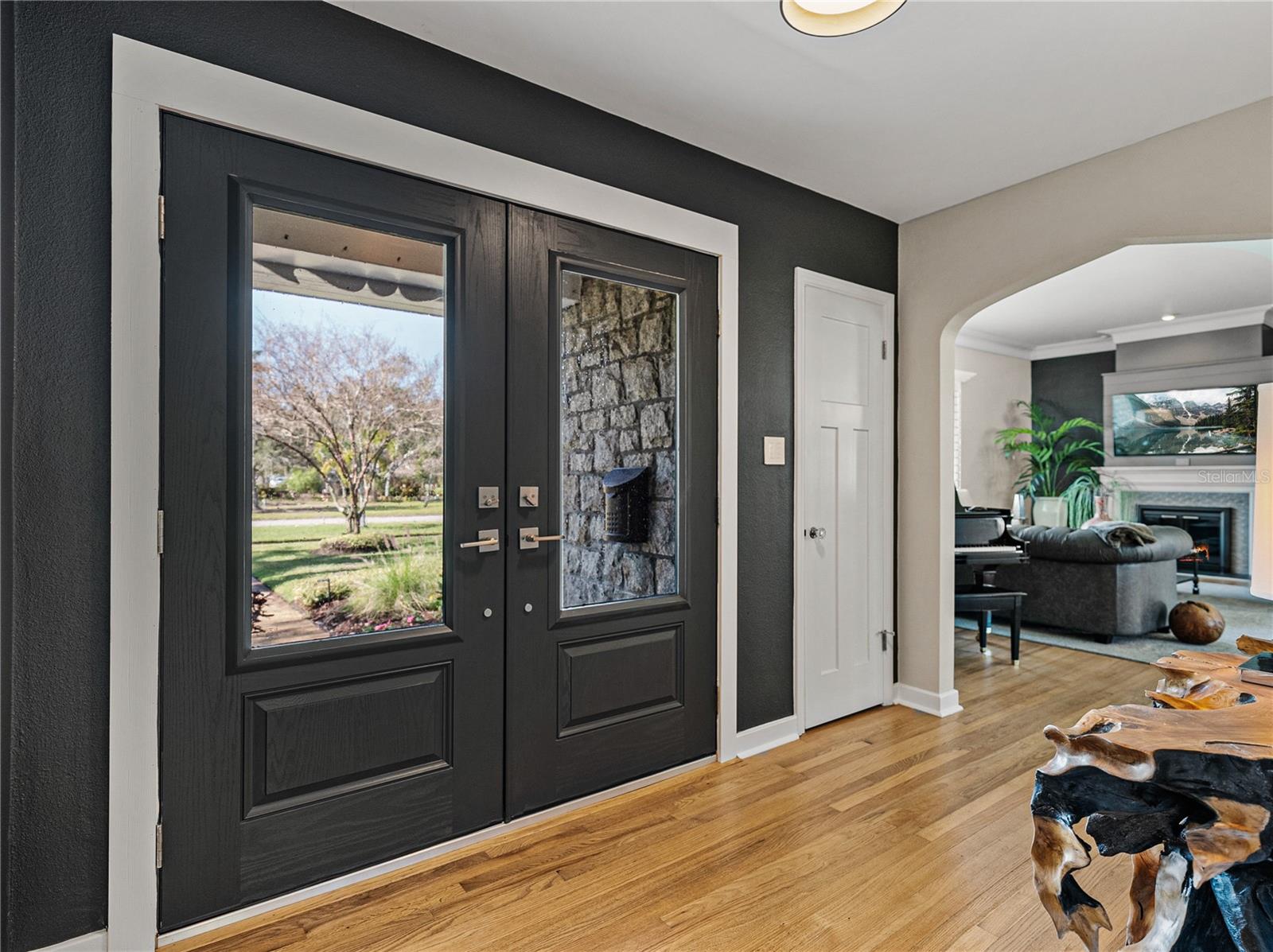 Oversized front doors greet guests into this stunning foyer.