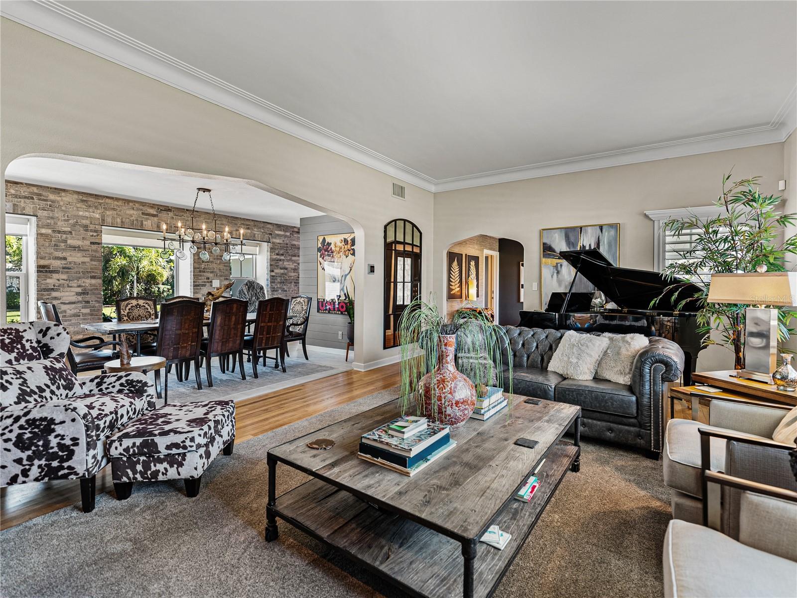 Living room, looking toward the oversized dining room and custom brick feature wall.