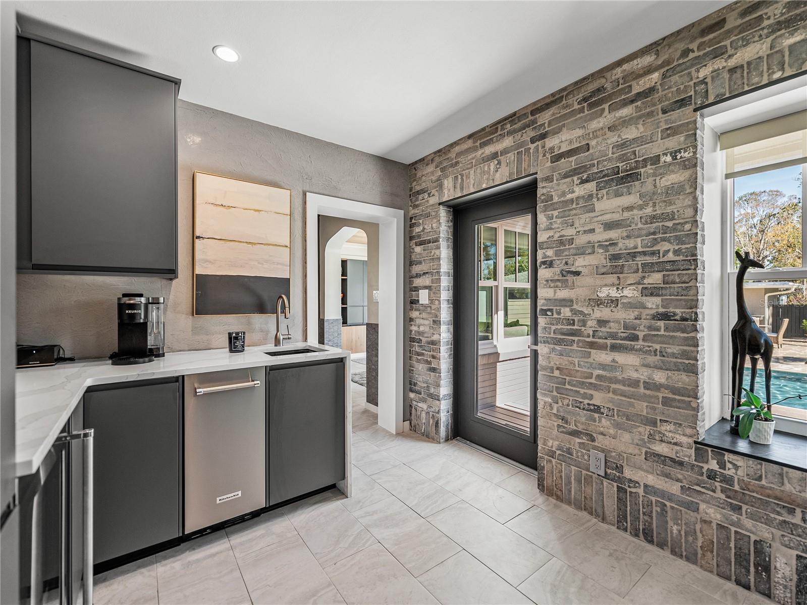 Wet bar with door to backyard oasis.