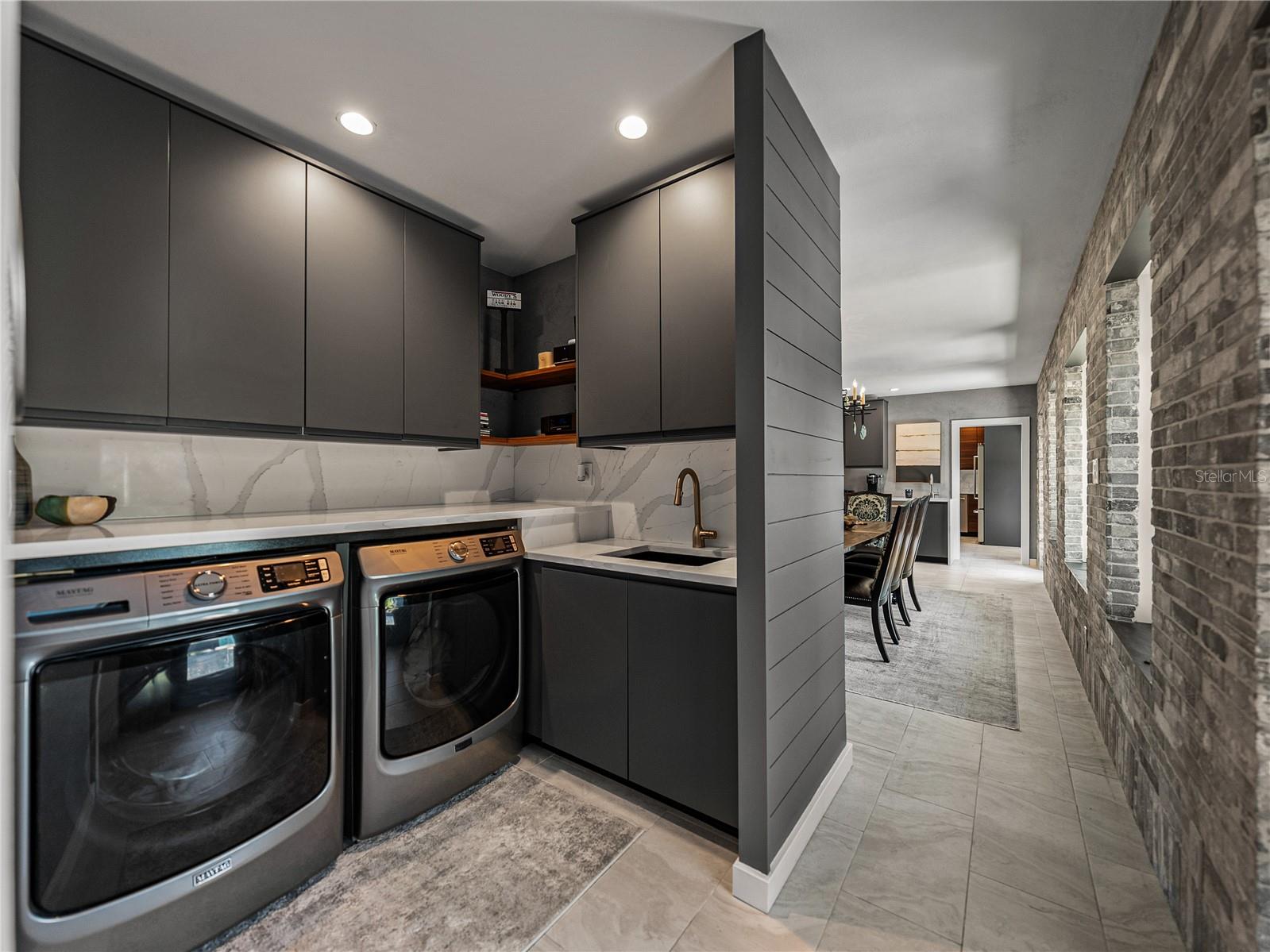 Fabulous interior laundry room with Maytag washer and dryer.