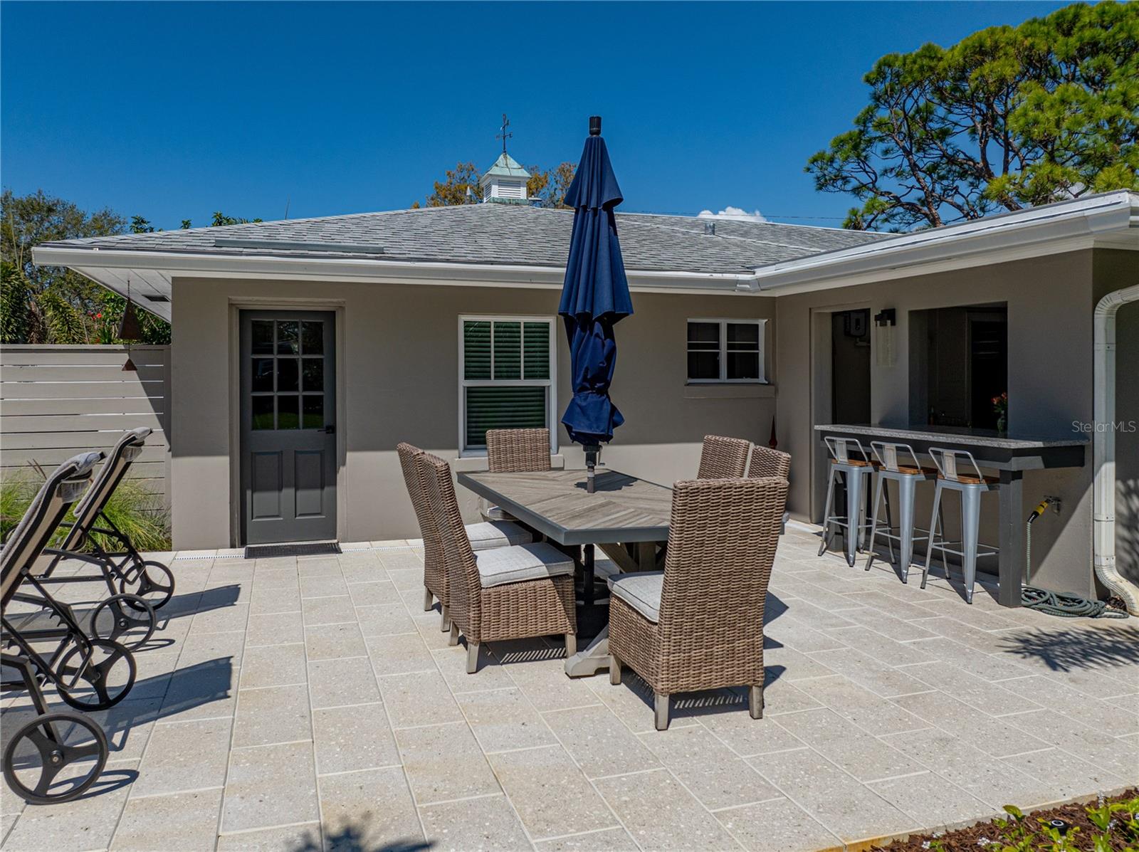 This separate structure offers so much! An unreal summer kitchen with outdoor bar, a mother-in-law suite, and climate controlled garage with space for 3 vehicles.