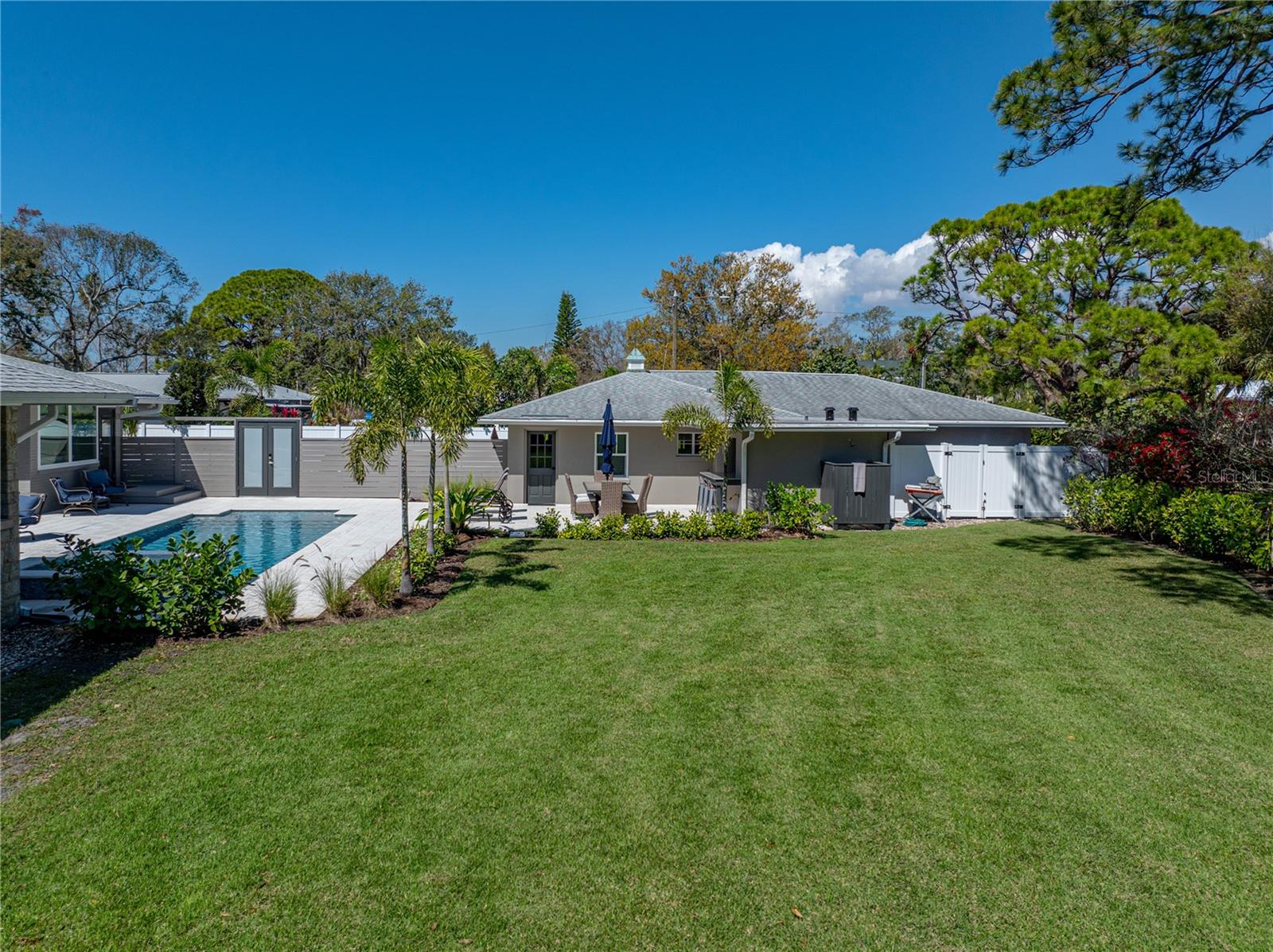 The enormous yard with lush landscaping.