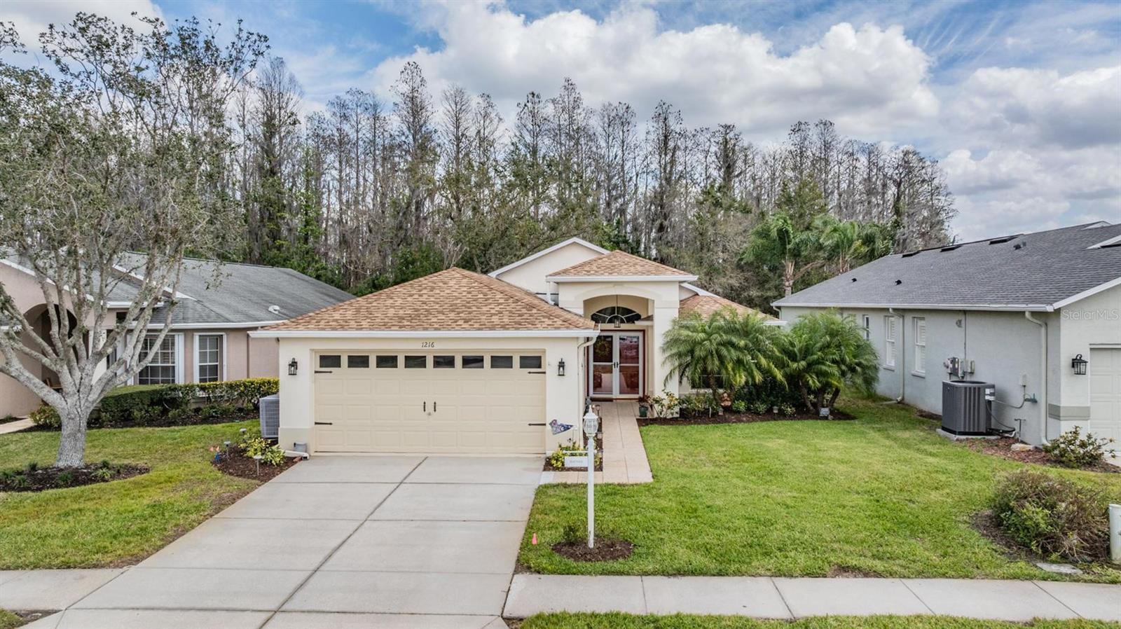 Covered entry and backyard tree-line view