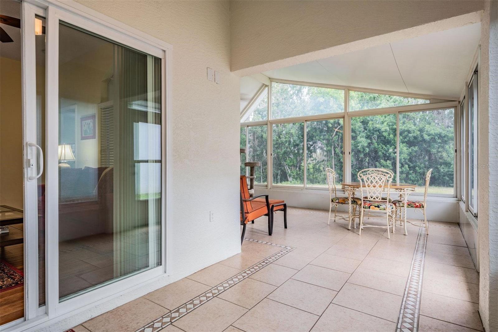 Sunroom with slider leading to living room