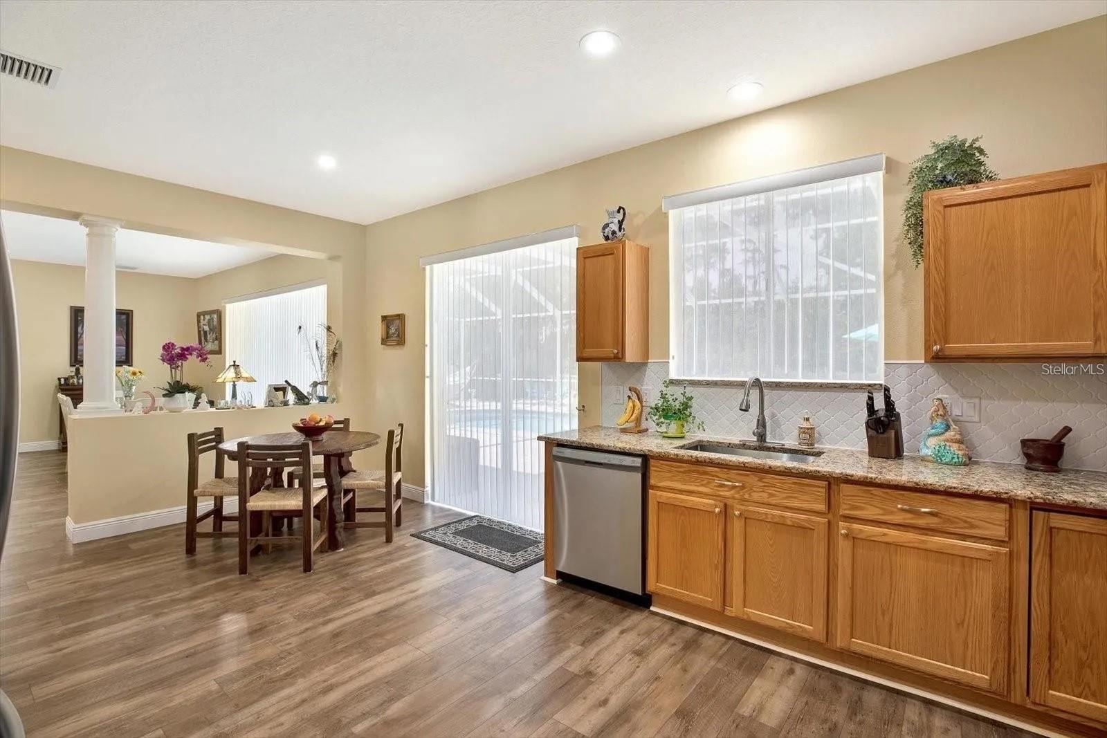 Sliding doors and kitchen window with upgraded See Through Vertical Blinds