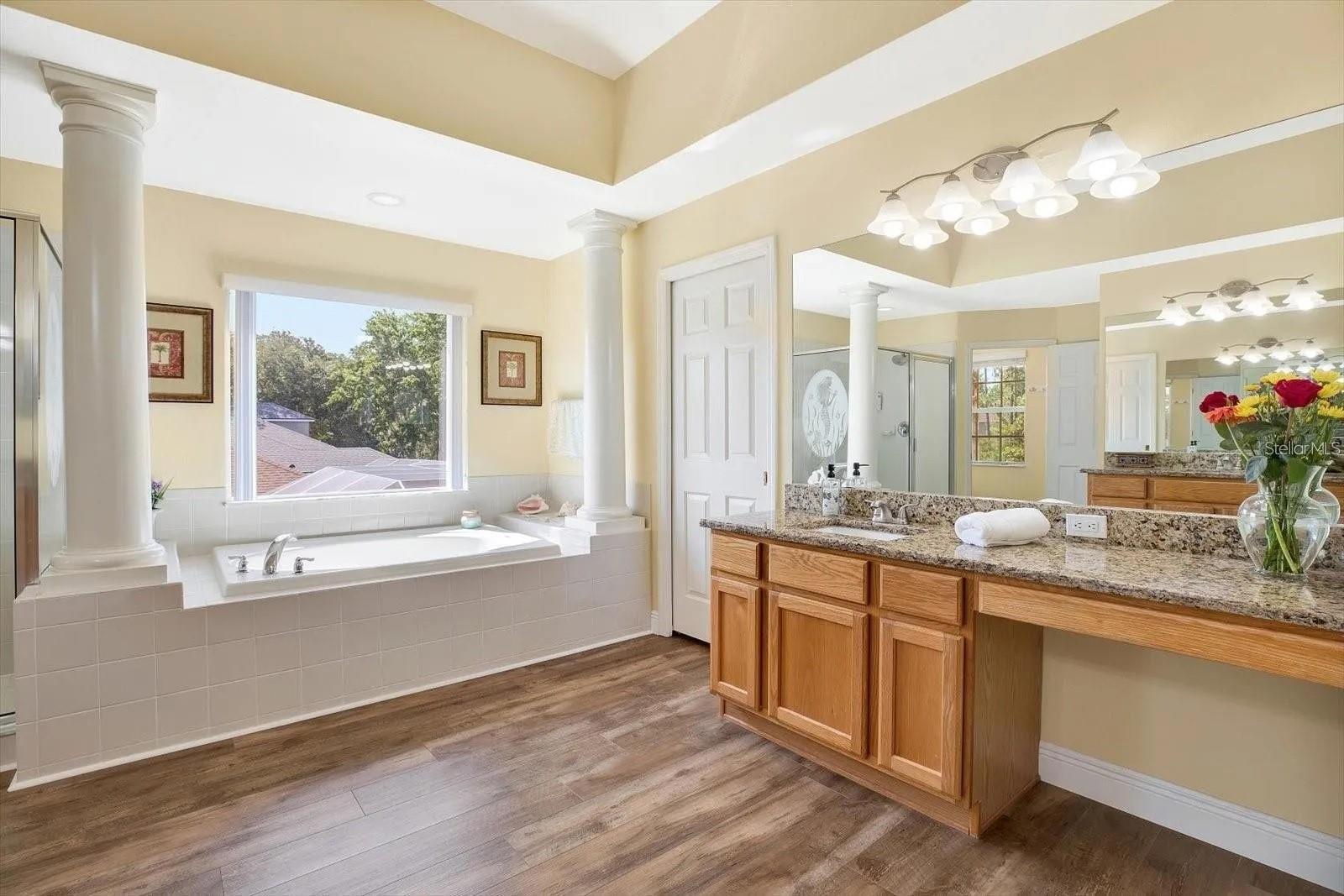 Relaxing garden tub with elegant Tuscan inspired columns