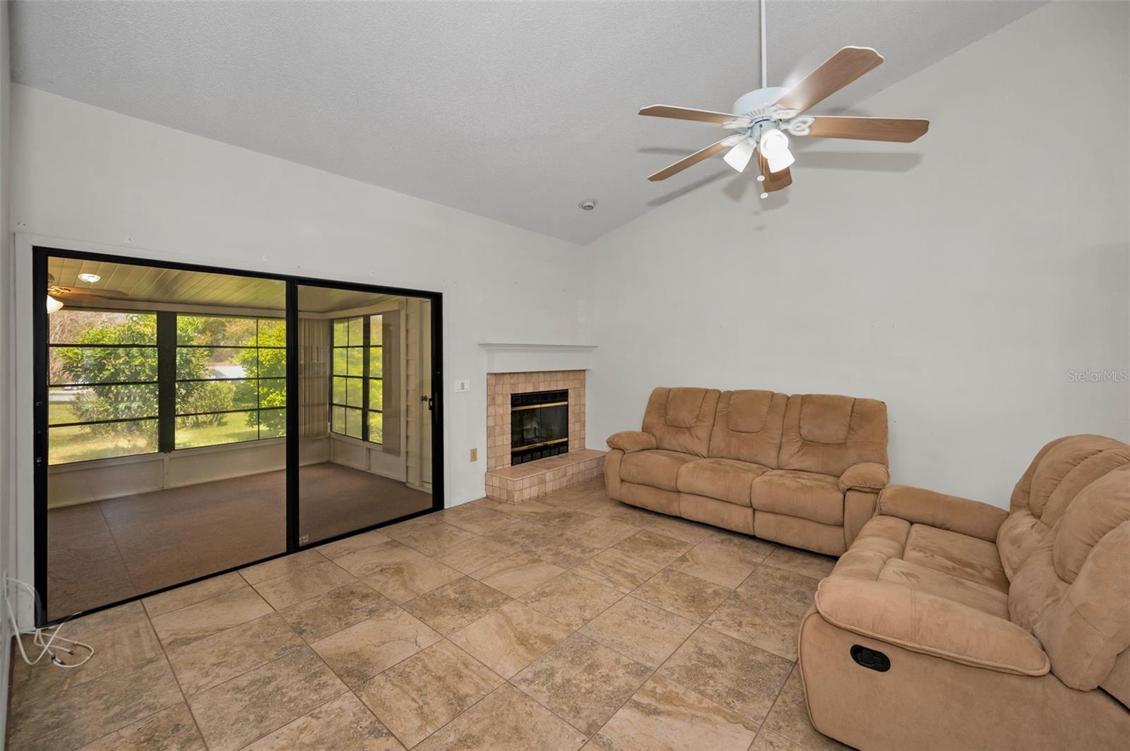 Family room with fireplace and views thru the sliders