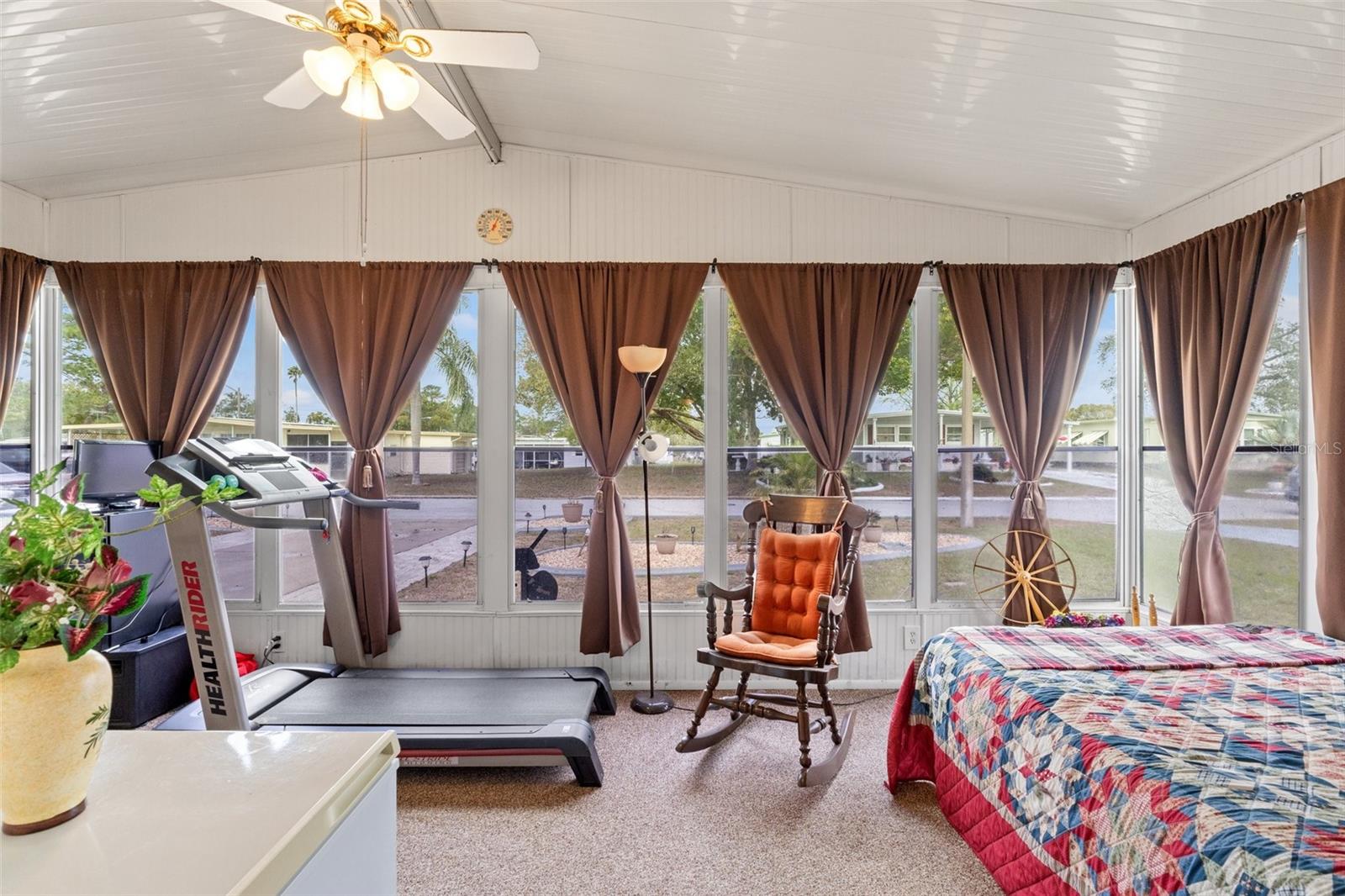 Florida Room - Currently being used as a bedroom - Moisture barrier installed beneath carpet - windows with screens and black out curtains