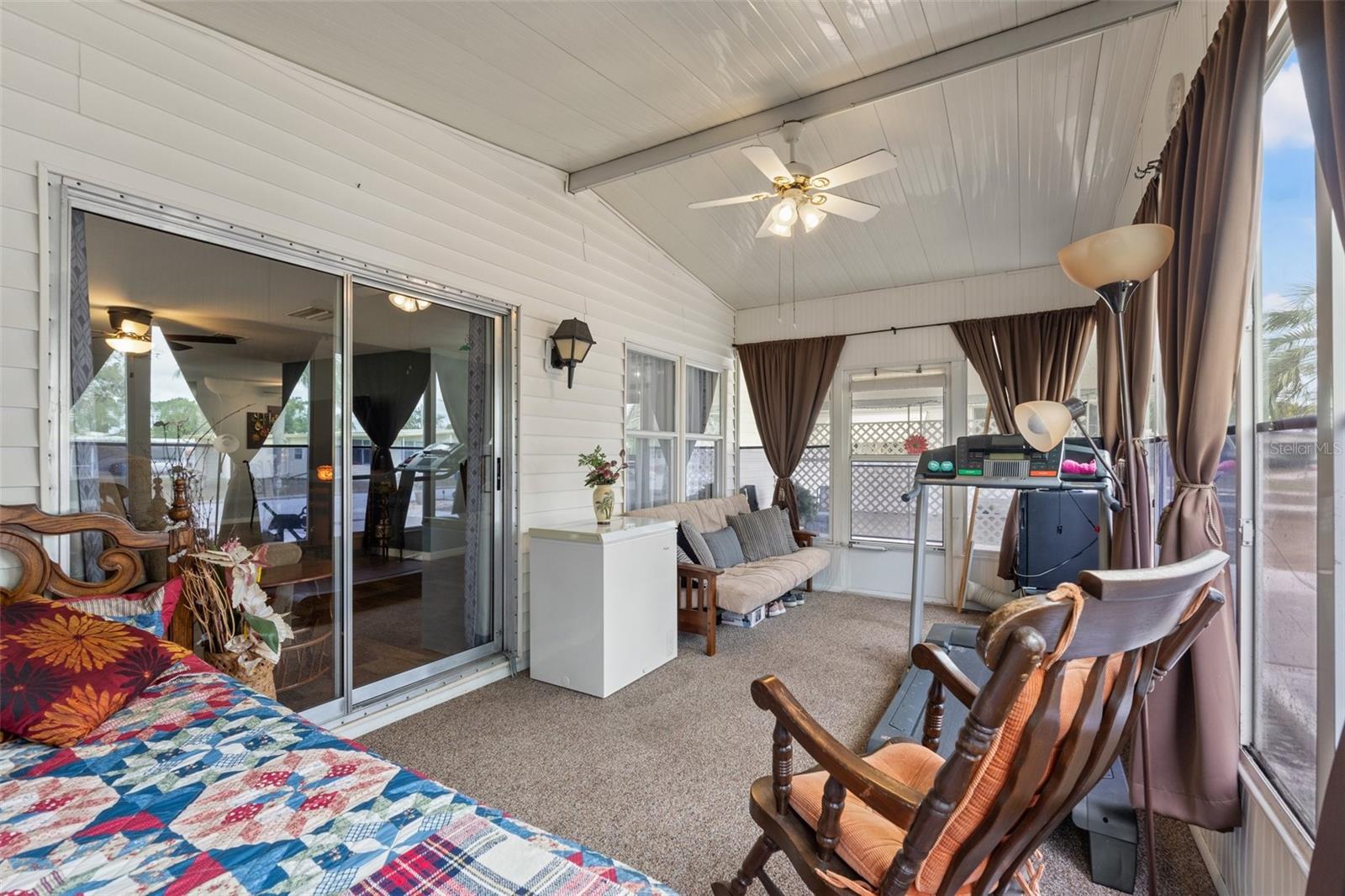 Florida Room - Currently being used as a bedroom - Moisture barrier installed beneath carpet - windows with screens and black out curtains