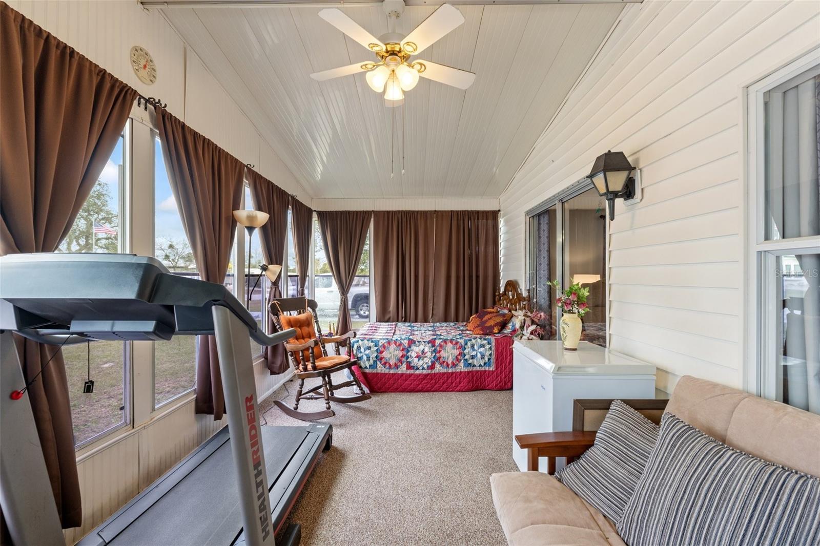 Florida Room - Currently being used as a bedroom - Moisture barrier installed beneath carpet - windows with screens and black out curtains