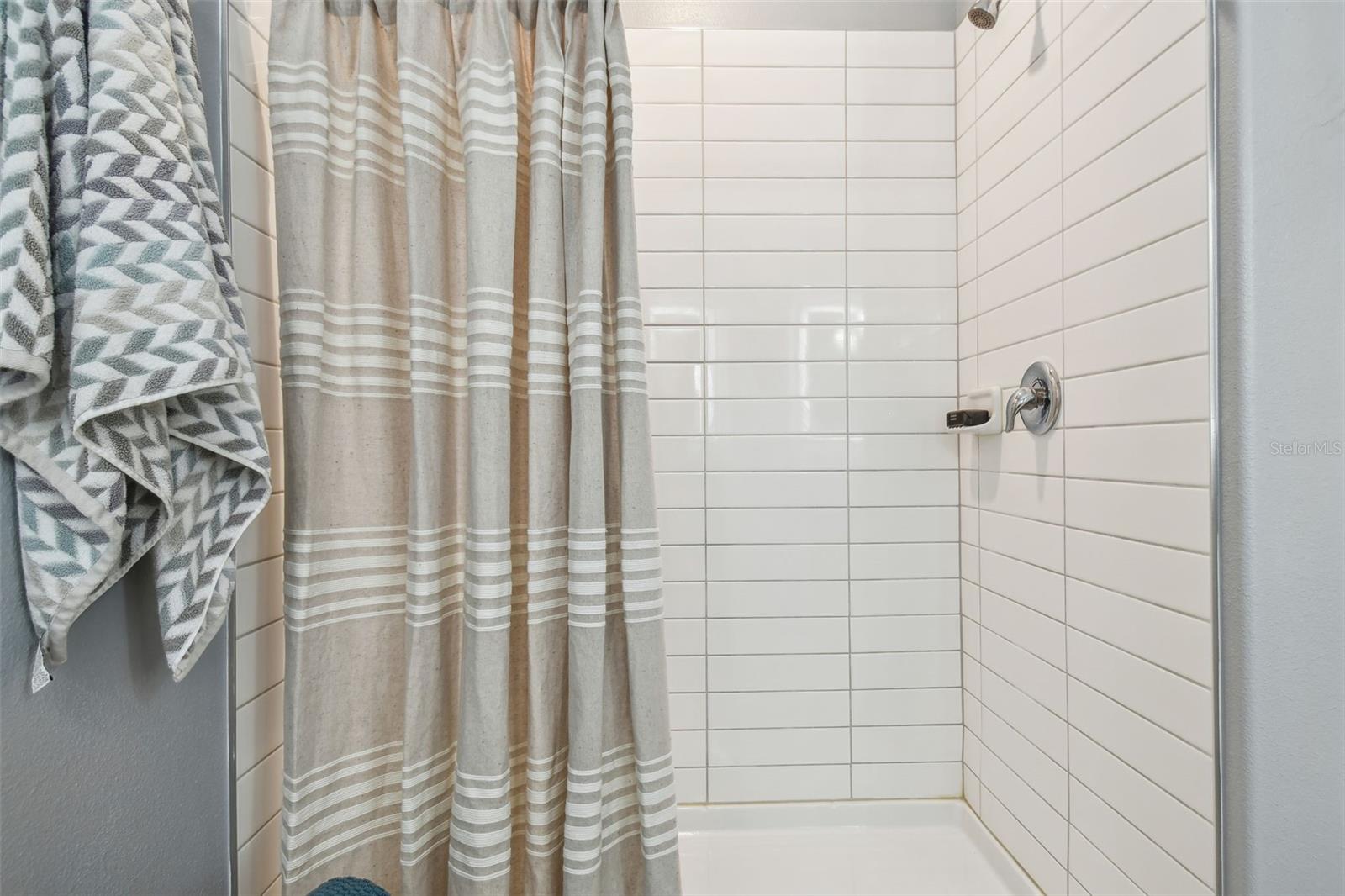 Large walk in shower with subway tiles