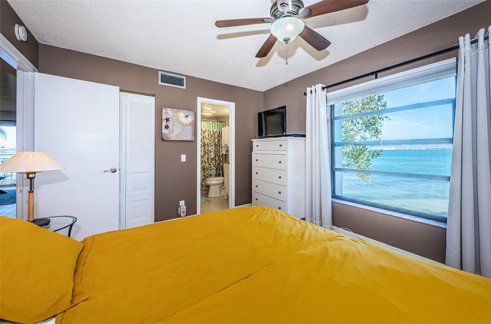 Primary bedroom with a private water view